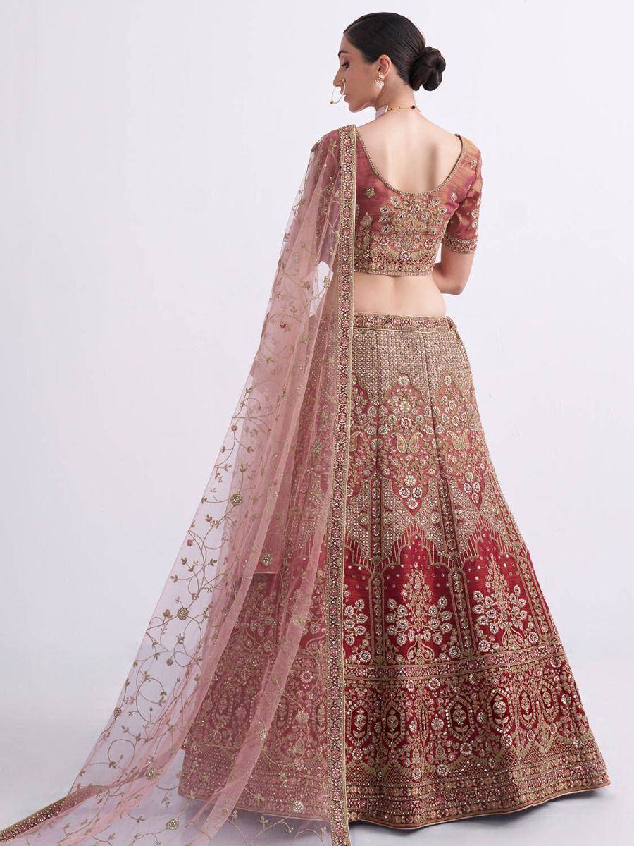 Elegant maroon lehenga choli with gold embroidery and sheer dupatta, perfect for Indian weddings and festive occasions.