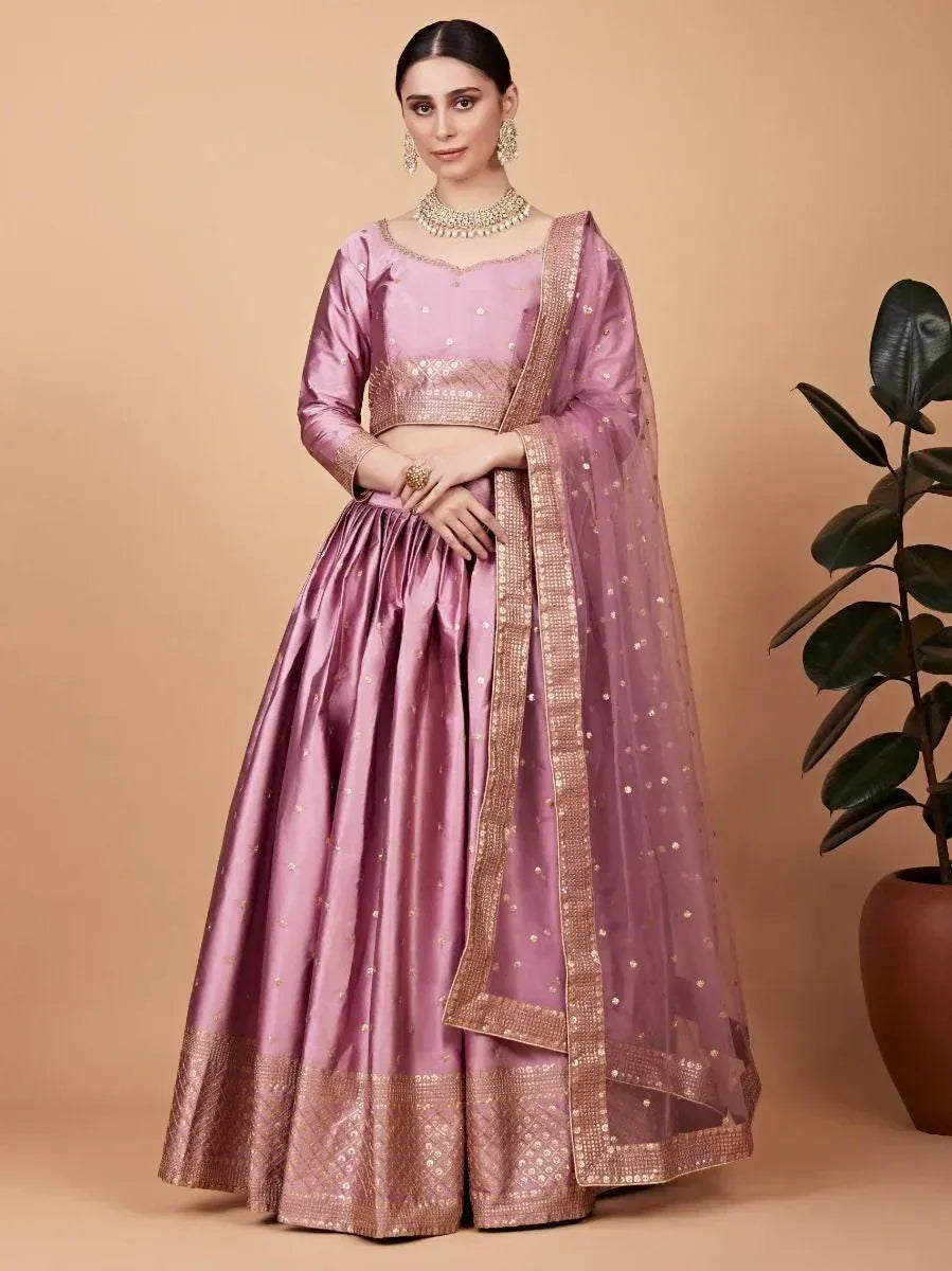 Elegant lavender lehenga choli with gold embroidery and sheer dupatta, perfect for Indian ethnic occasions.