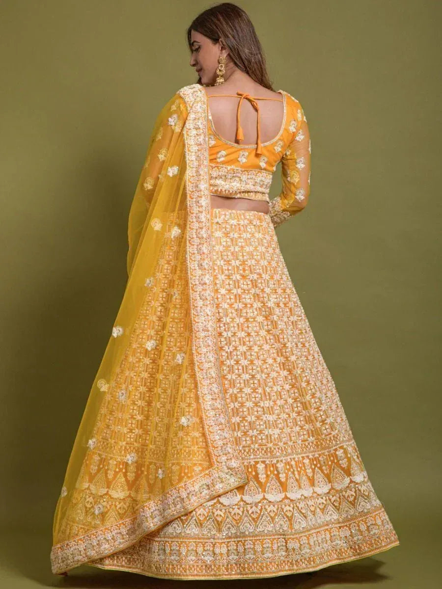 Yellow embroidered lehenga choli with floral motifs and back tie blouse, perfect for Indian ethnic occasions
