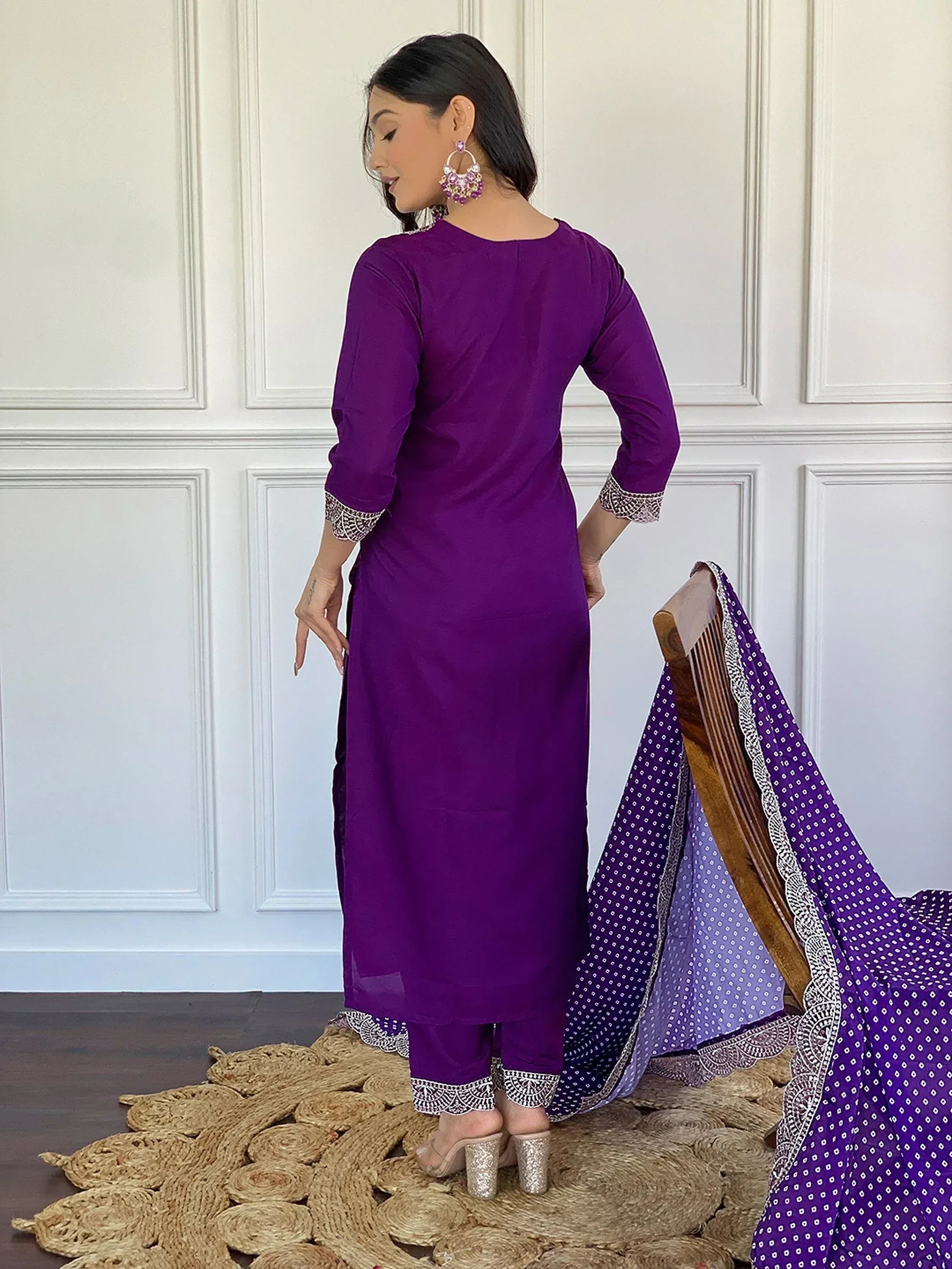 Purple ethnic salwar kameez with silver embroidery, paired with printed dupatta and statement earrings