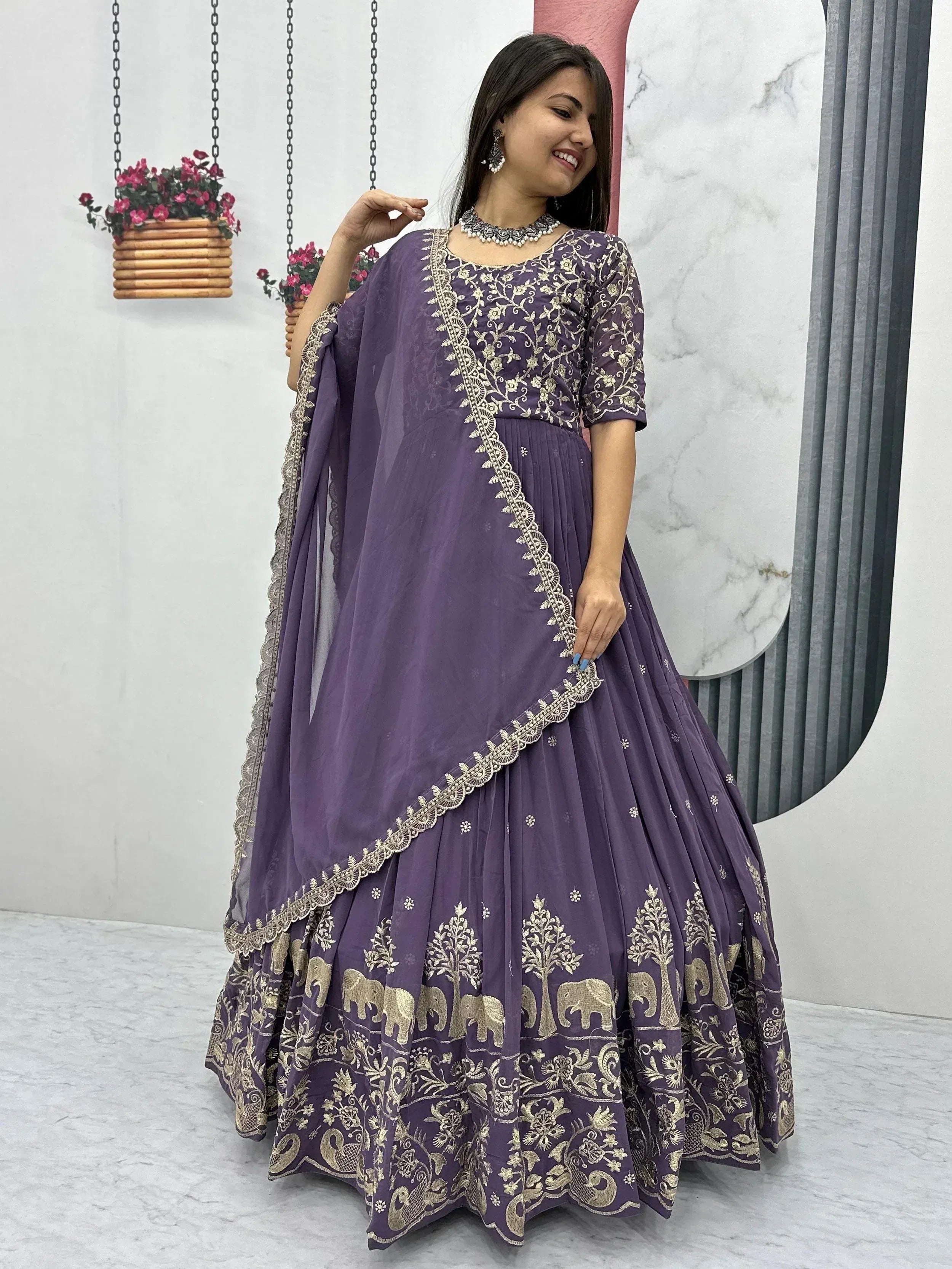 Purple embroidered lehenga choli with gold elephant and tree motifs, perfect for Indian ethnic wear