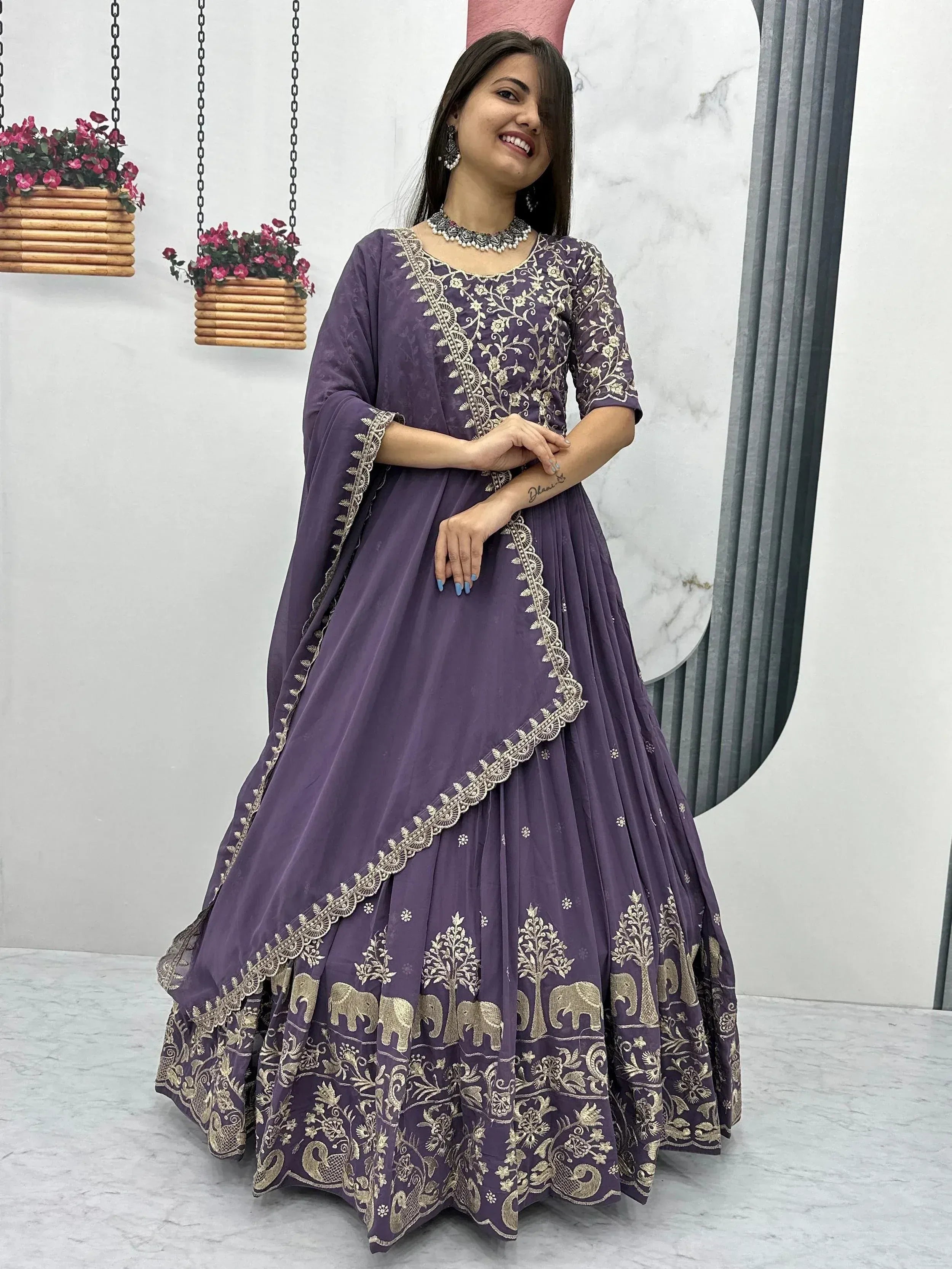 Purple embroidered lehenga choli with gold elephant and tree motifs, perfect for Indian ethnic wear occasions