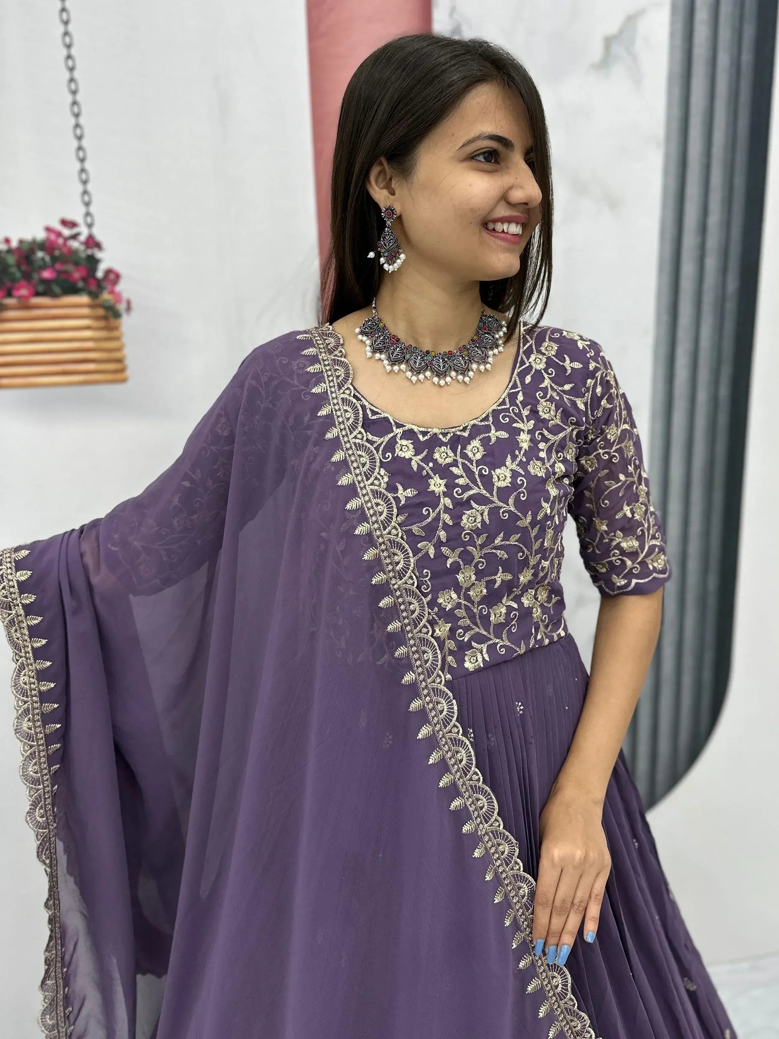 Purple embroidered ethnic gown with gold floral work, perfect for Indian occasions and festive wear.