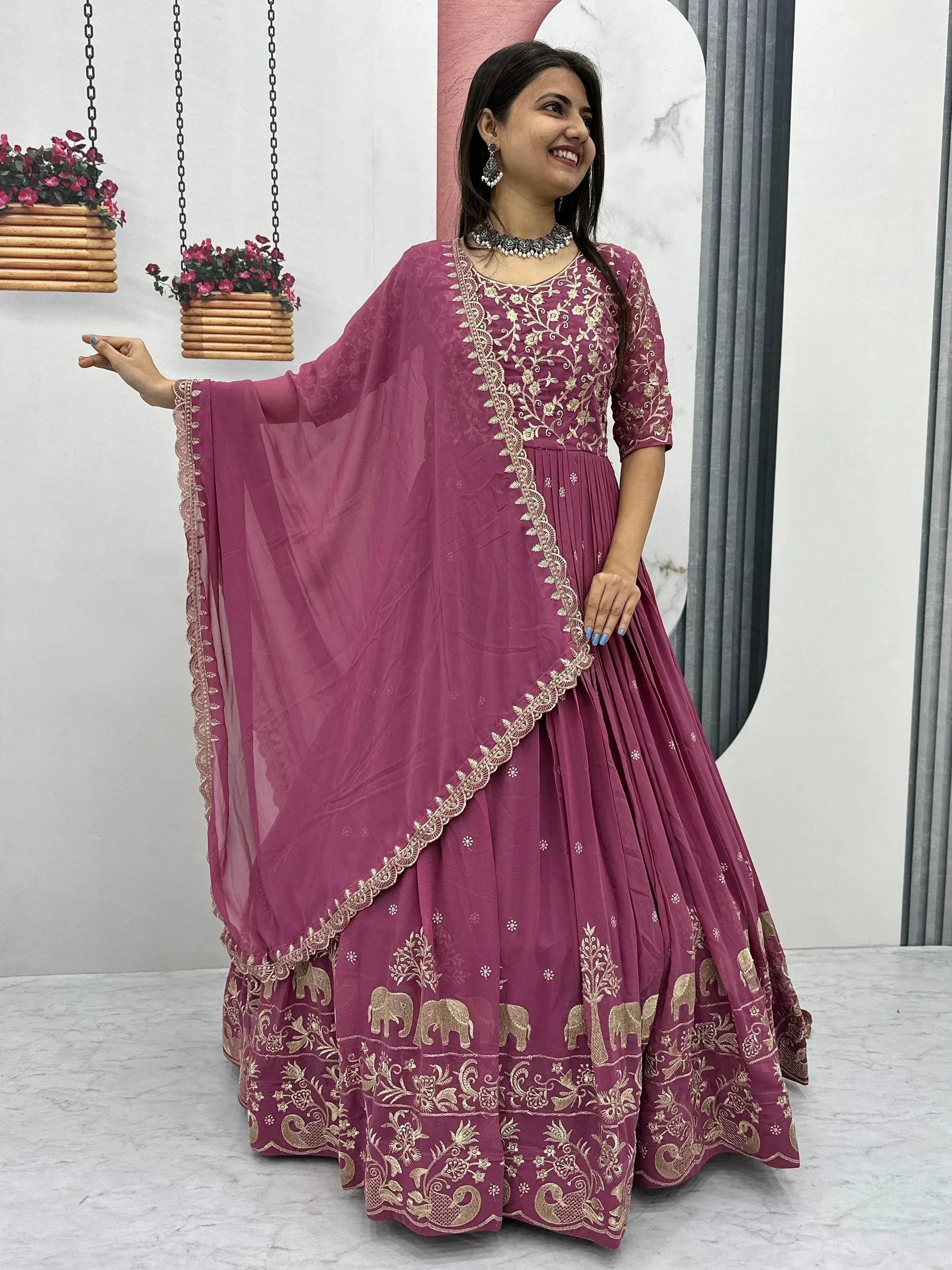 Purple Indian ethnic anarkali with gold elephant embroidery and floral detailing, perfect for festive occasions.