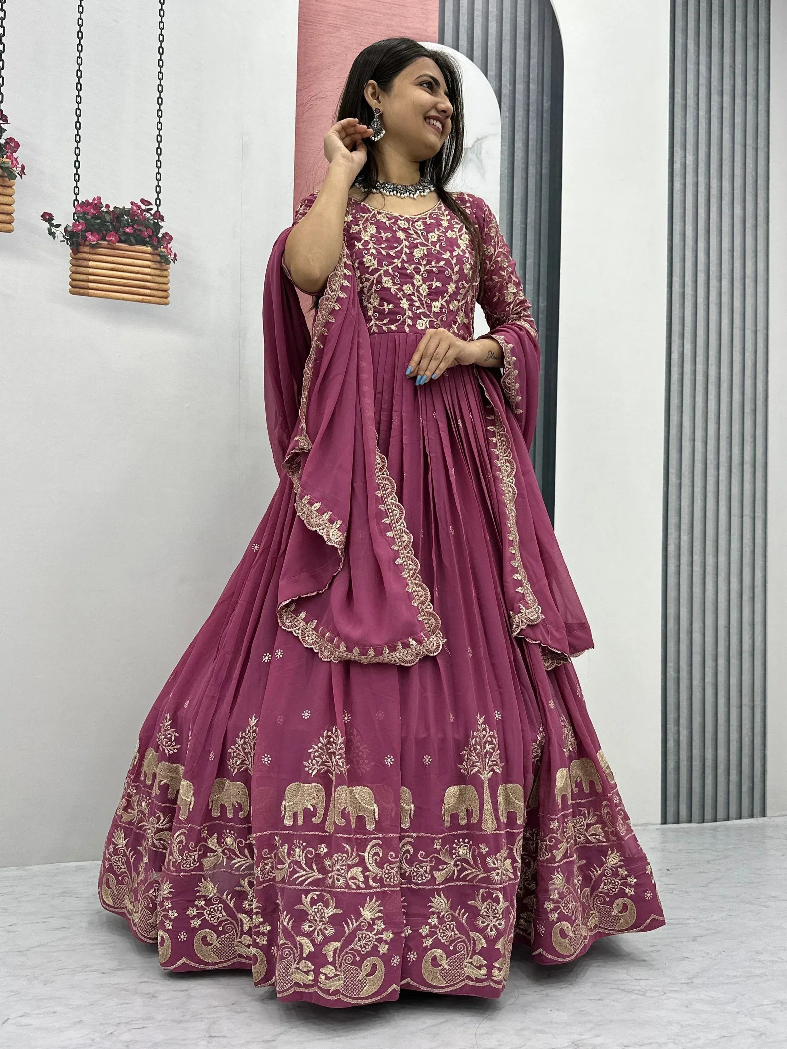 Elegant maroon Indian anarkali with gold elephant and floral embroidery, perfect for festive occasions