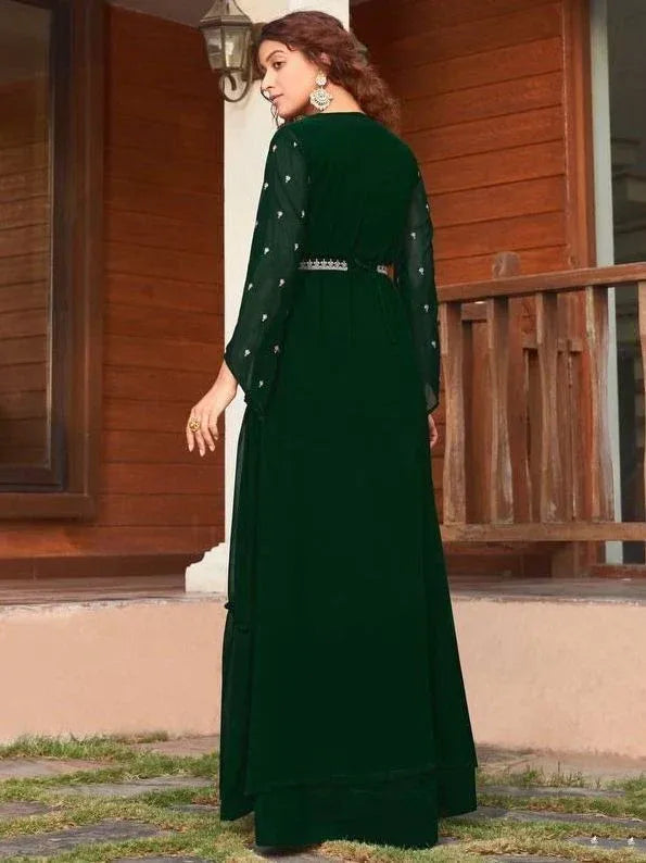 Emerald green ethnic gown with sheer sleeves and embellished belt, perfect for Indian occasions