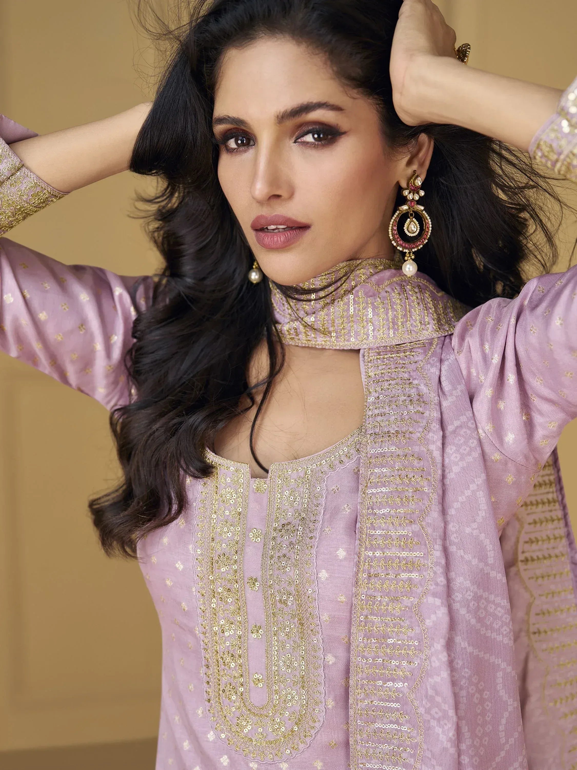 Elegant lavender ethnic kurta with gold embroidery and statement earrings for festive occasions