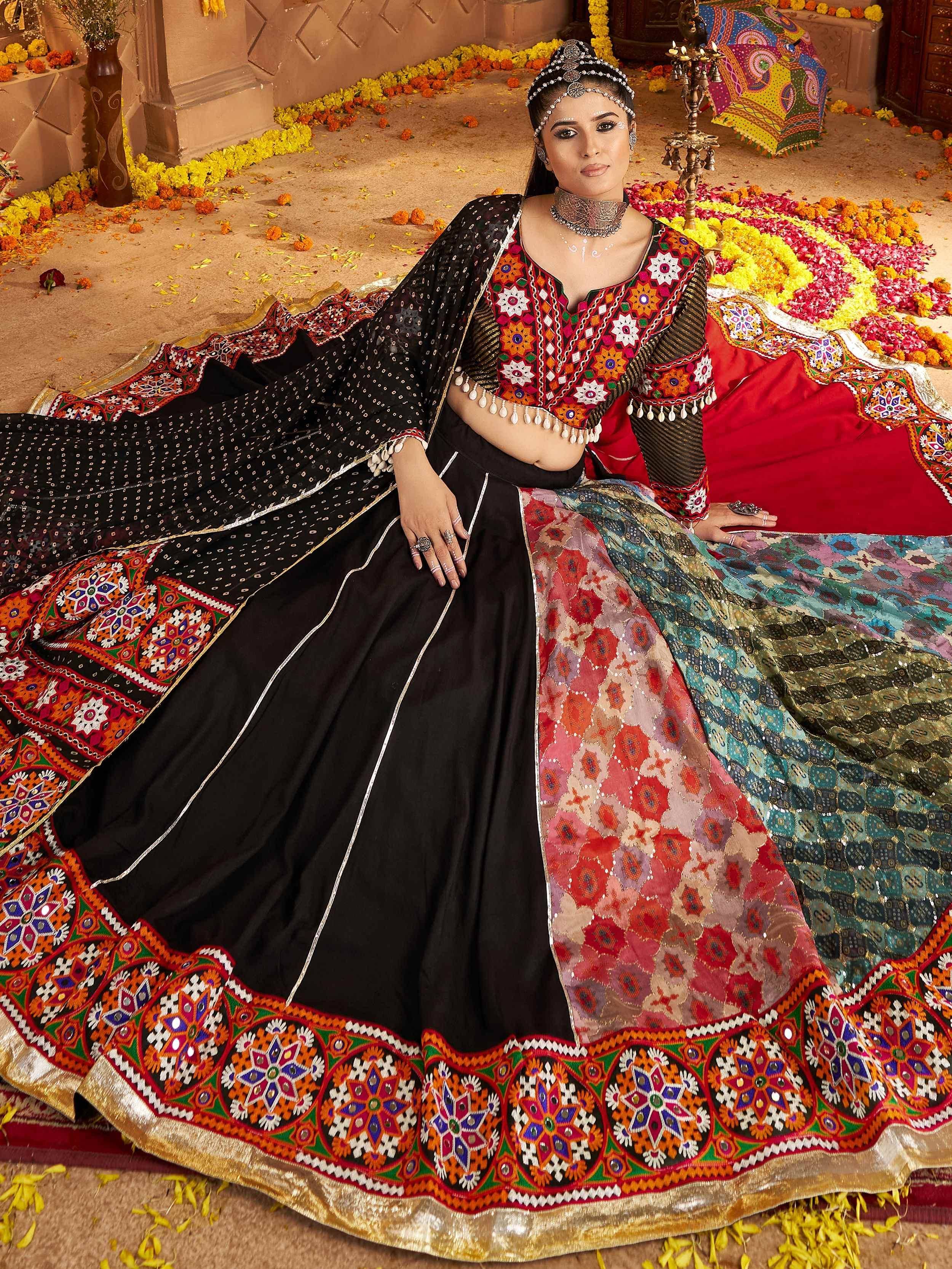 Woman in vibrant ethnic lehenga choli with mirror work, floral patterns, and traditional jewelry for festive occasions