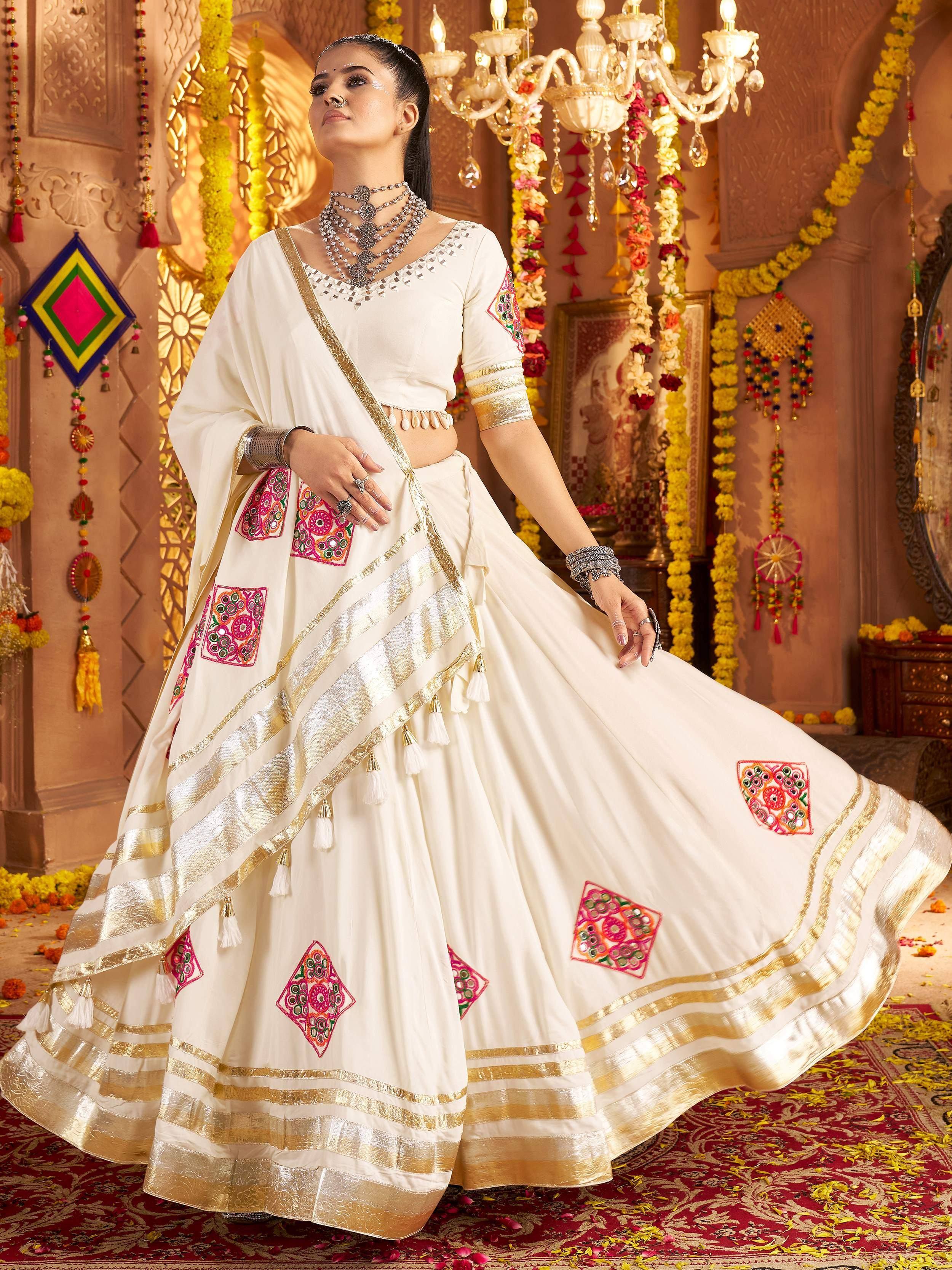 White embroidered lehenga choli with gold border, perfect for Indian weddings and festive occasions