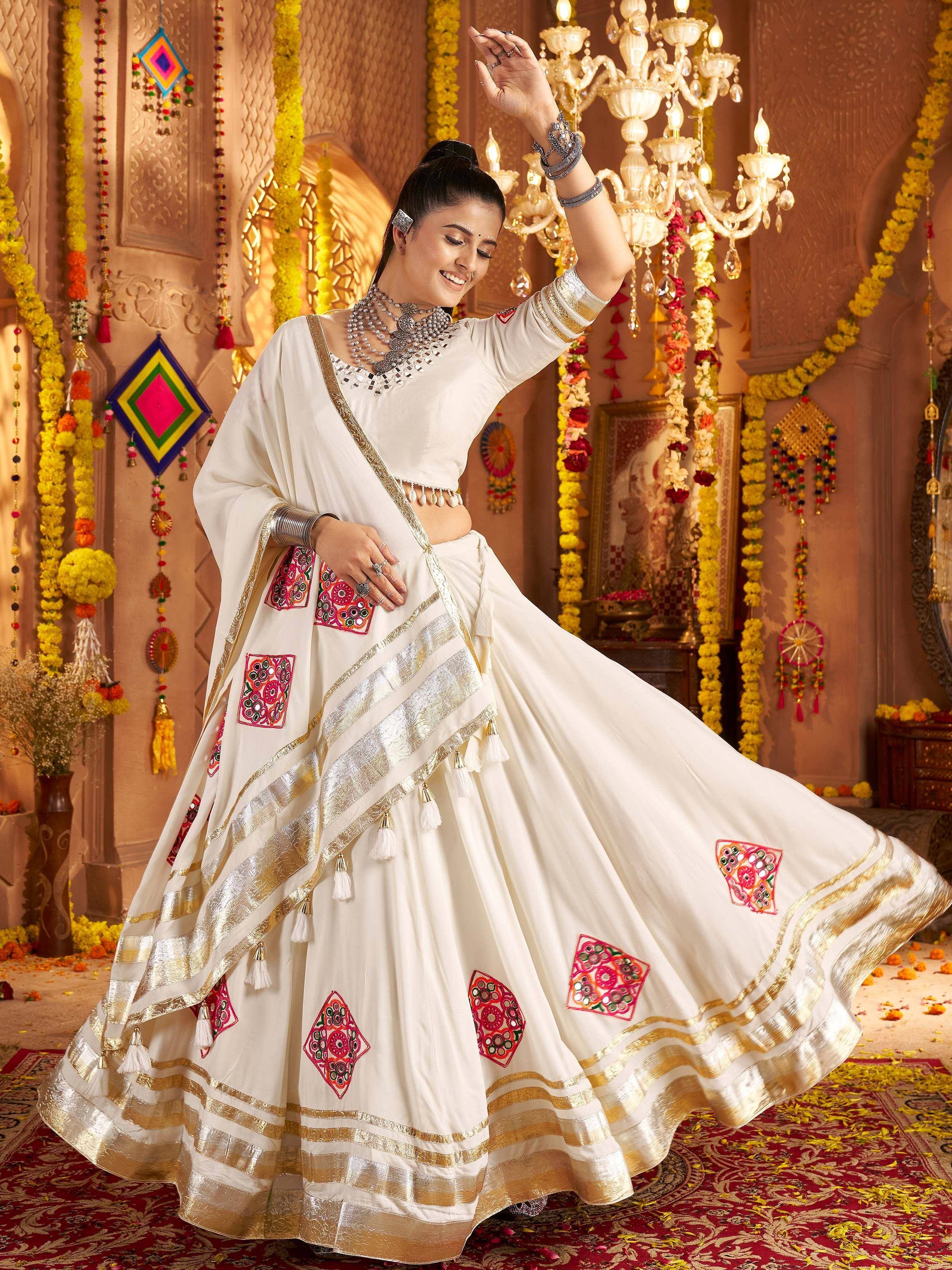 White embroidered lehenga choli with gold trim, perfect for Indian ethnic wear and festive occasions.
