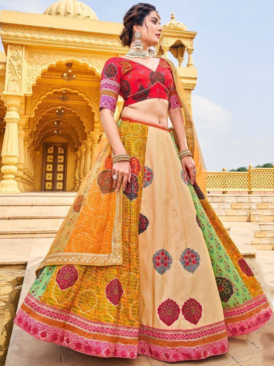 Woman in vibrant red and gold designer lehenga choli with floral embroidery, perfect for Indian ethnic wear occasions