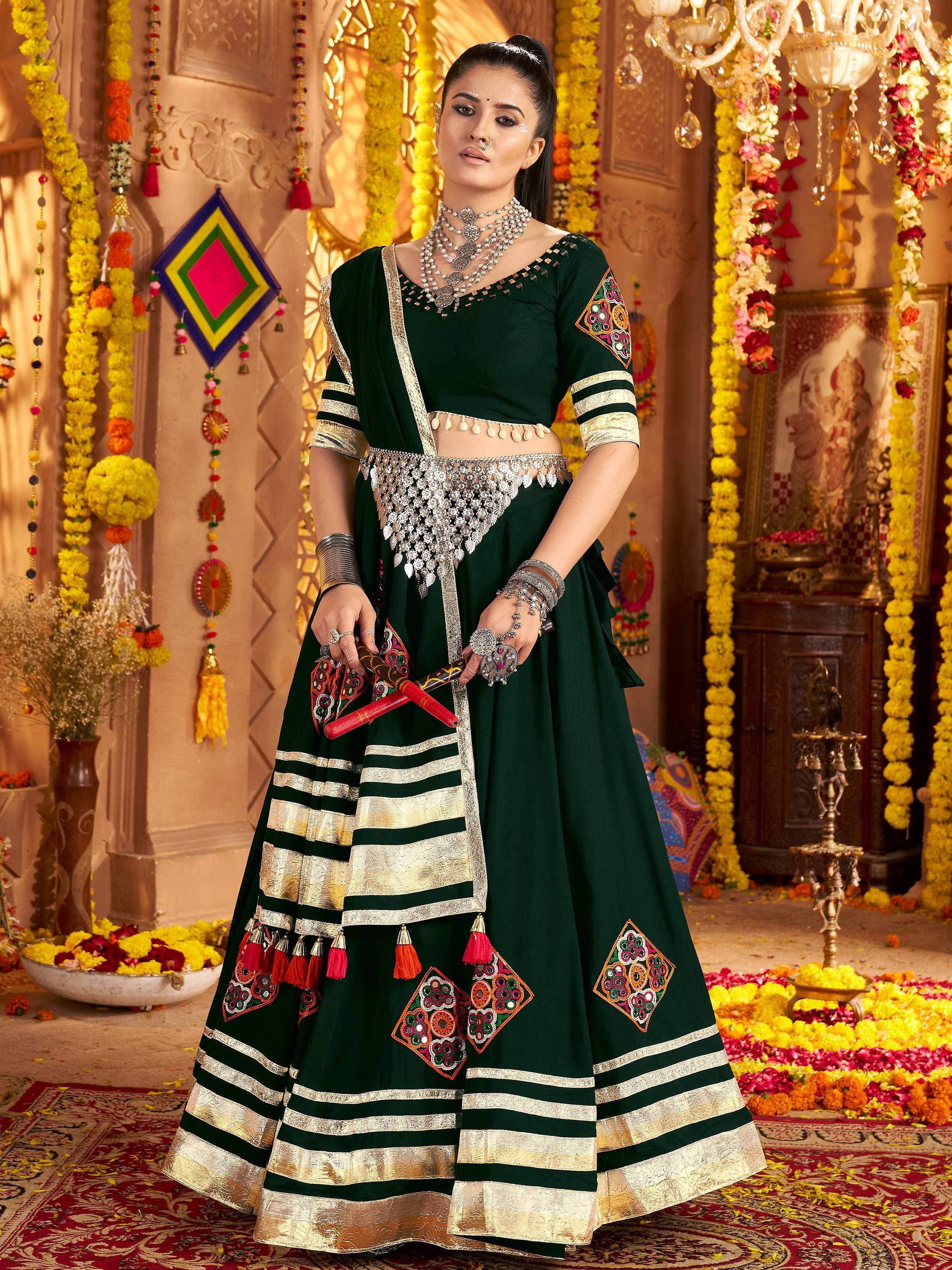 Green ethnic lehenga choli with mirror work, gold stripes, and tassels for Indian festivals and weddings