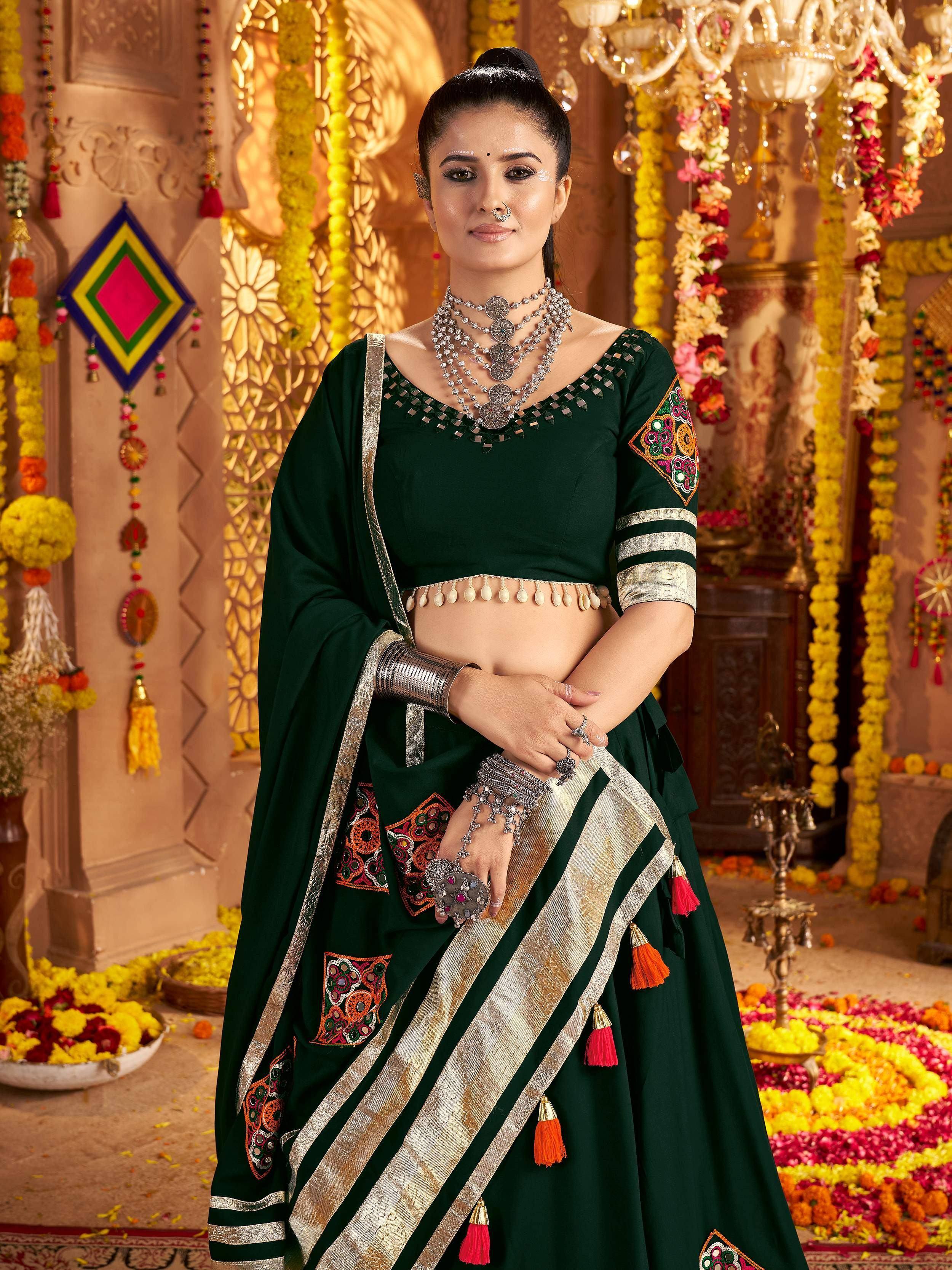 Emerald green designer lehenga choli with mirror work, gold border, and floral embroidery for Indian weddings