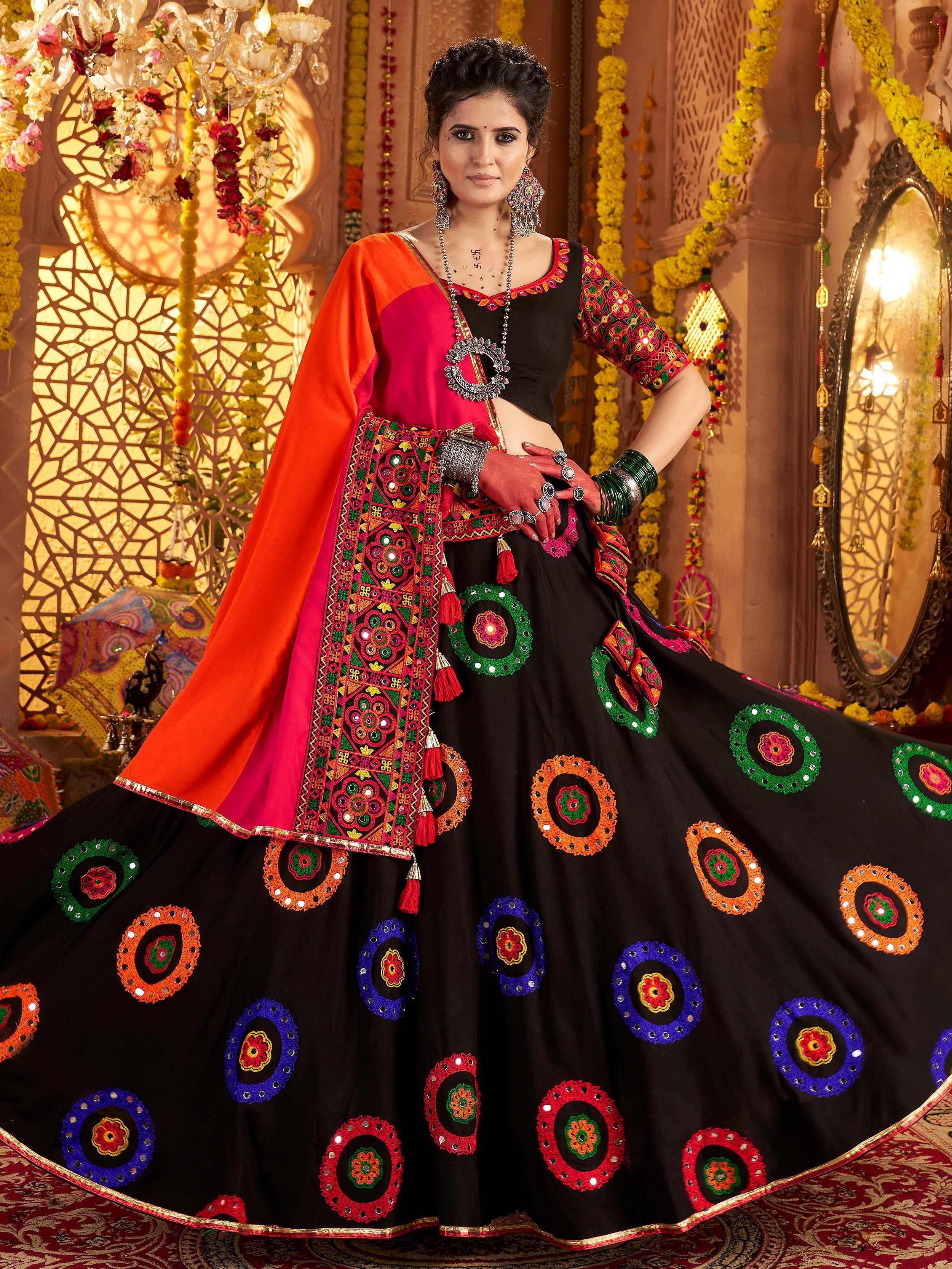 Black embroidered lehenga choli with colorful mirror work, orange dupatta, festive Indian ethnic wear