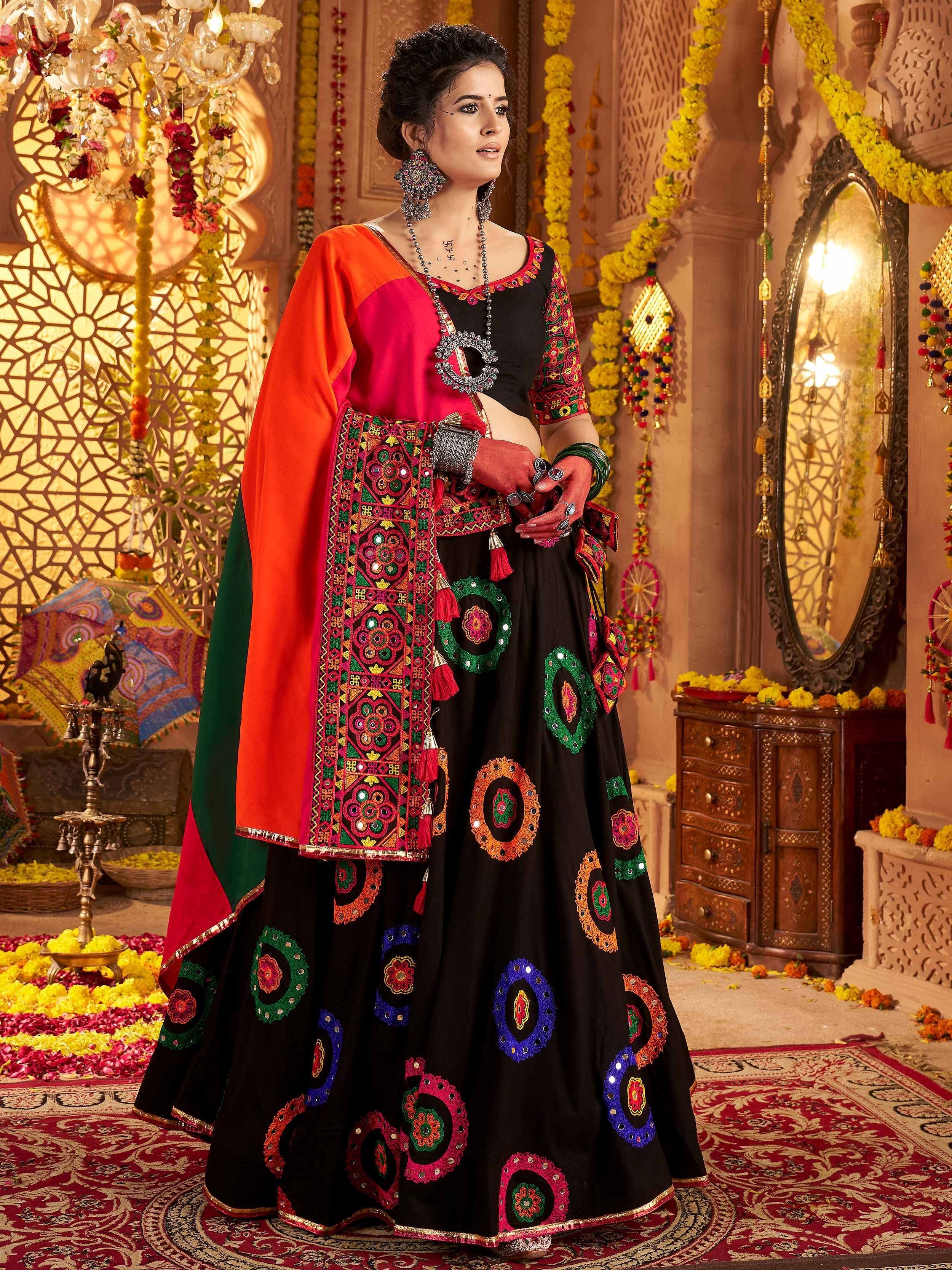 Black embroidered lehenga choli with colorful mirror work, orange dupatta, traditional Indian ethnic wear