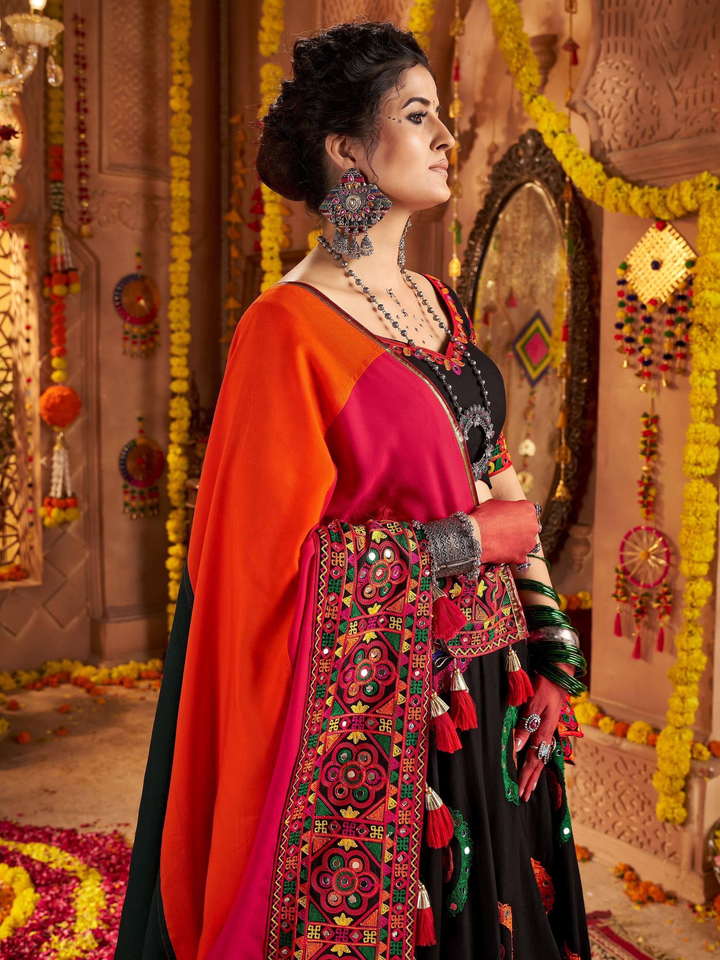 Woman in vibrant Indian ethnic wear with mirror work, floral garlands, and traditional jewelry
