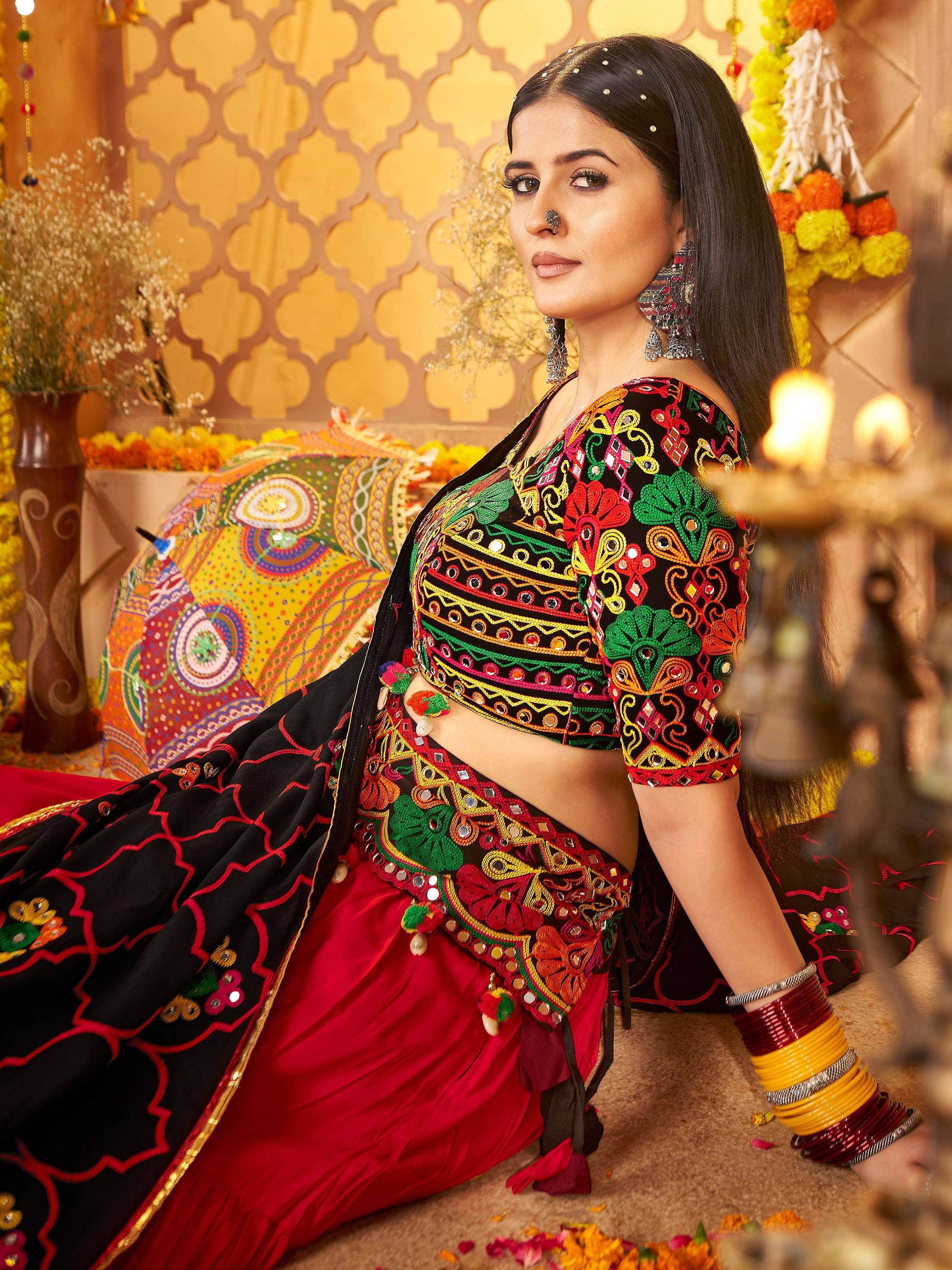 Woman in vibrant embroidered lehenga choli with mirror work, traditional Indian ethnic wear for festive occasions