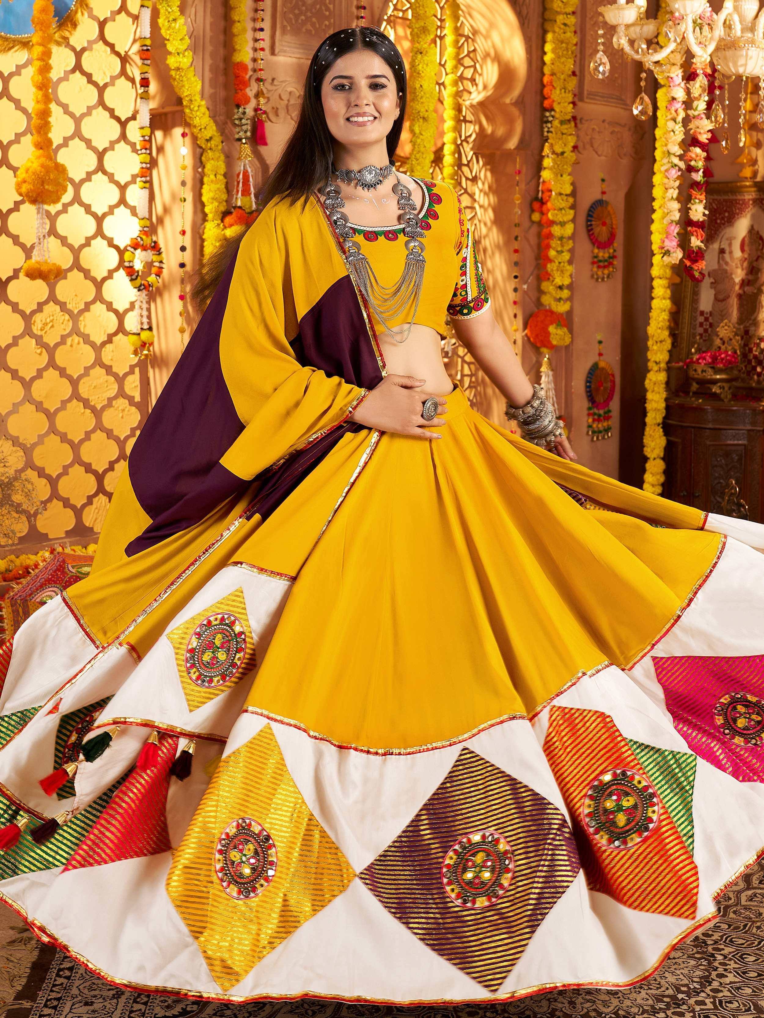 Yellow and purple designer lehenga choli with mirror work, perfect for Indian ethnic wear and festive occasions