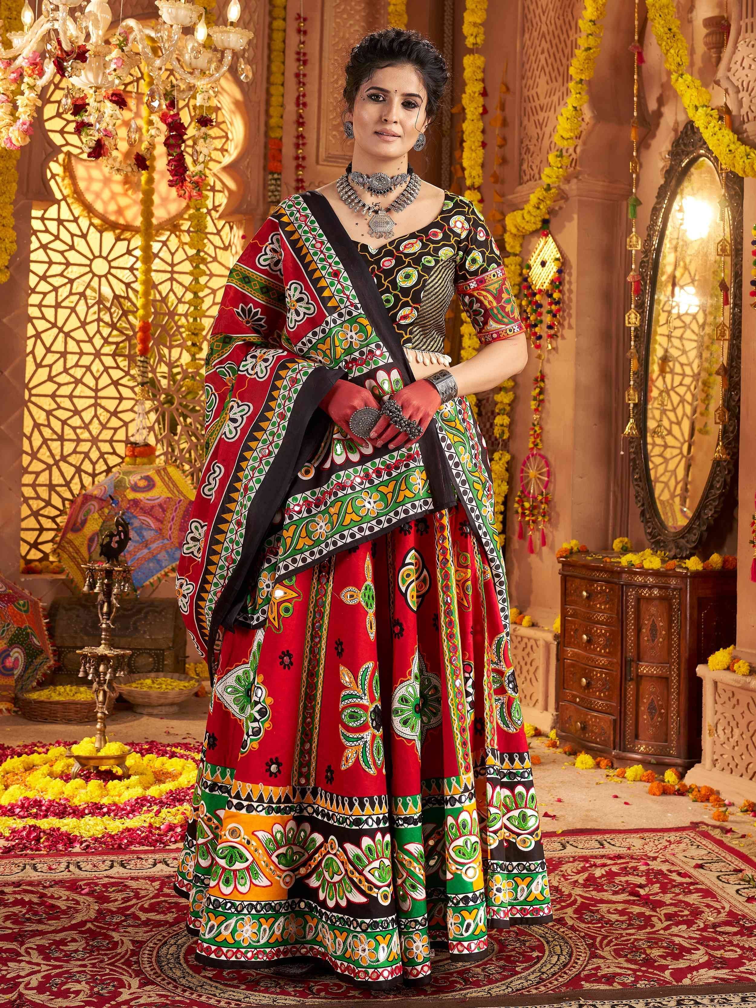 Vibrant red and green printed lehenga choli with mirror work, perfect for Indian ethnic occasions