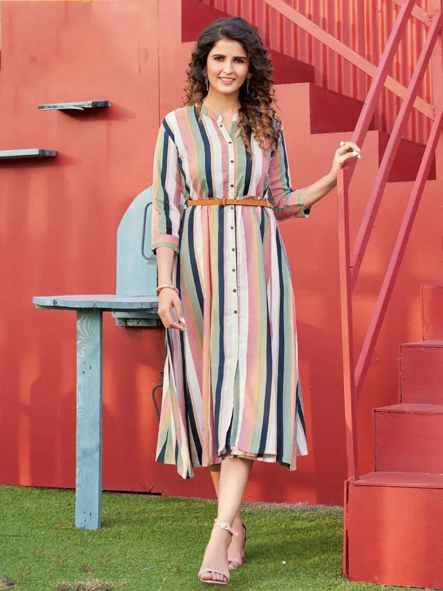 Woman in colorful striped ethnic gown with belt, standing by red stairs, perfect for casual occasions.