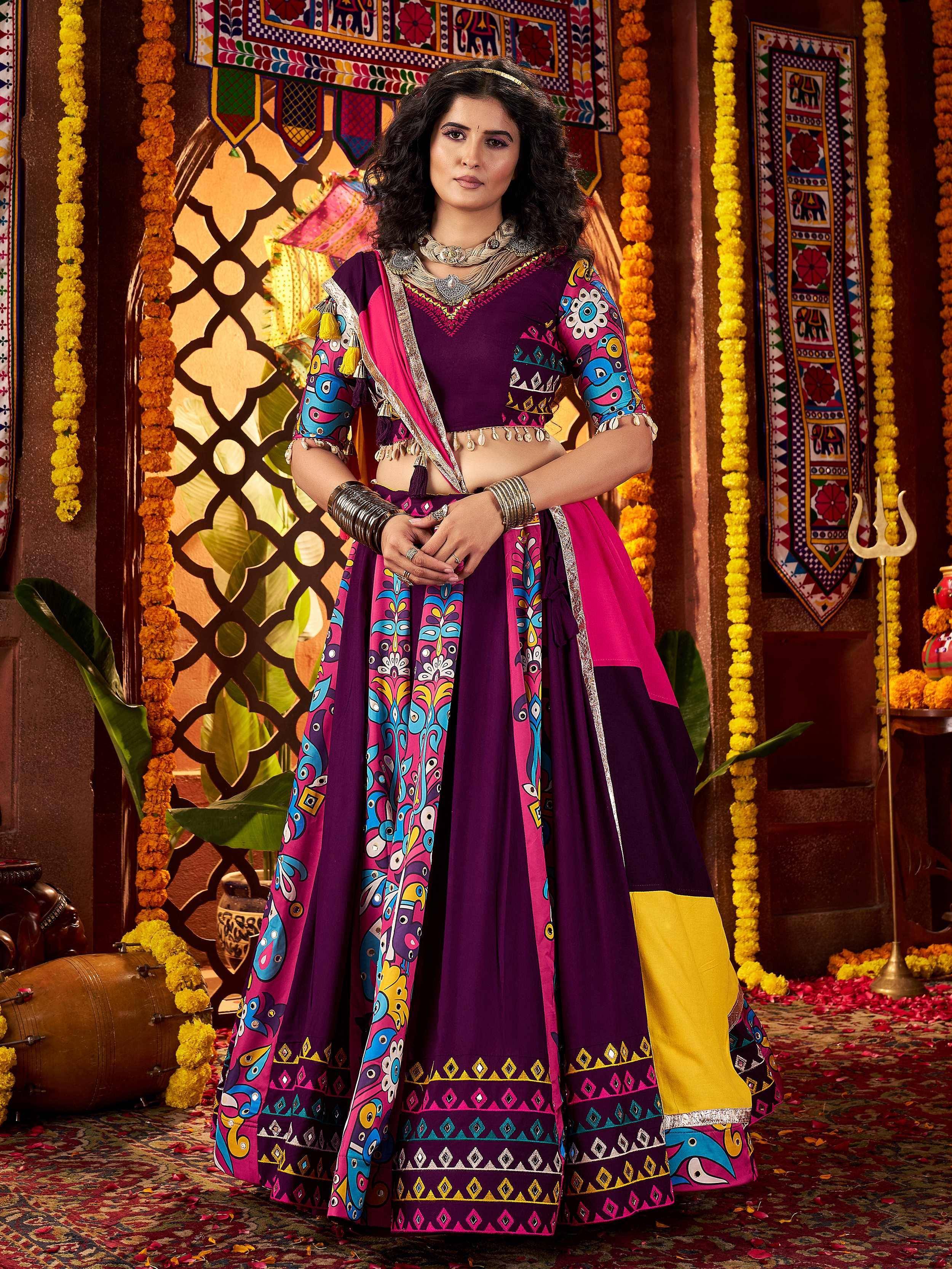 Vibrant purple and pink printed lehenga choli with ethnic embroidery, perfect for Indian festivals and weddings.