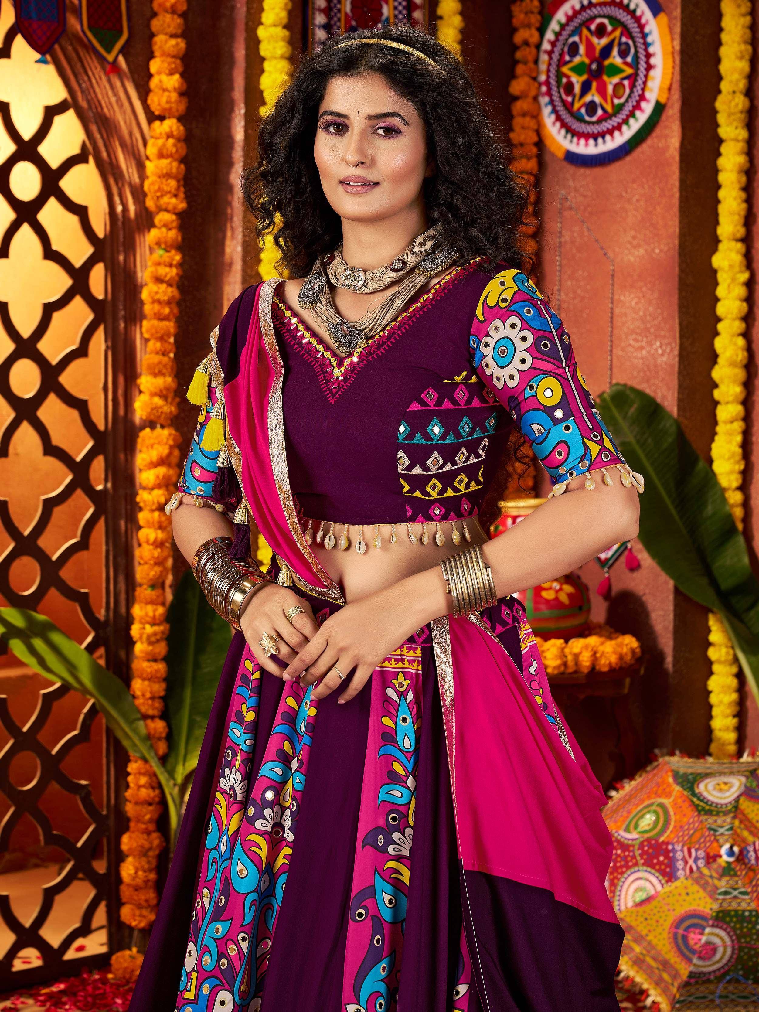 Vibrant purple and pink printed lehenga choli with mirror work, perfect for Indian ethnic wear and festive occasions.