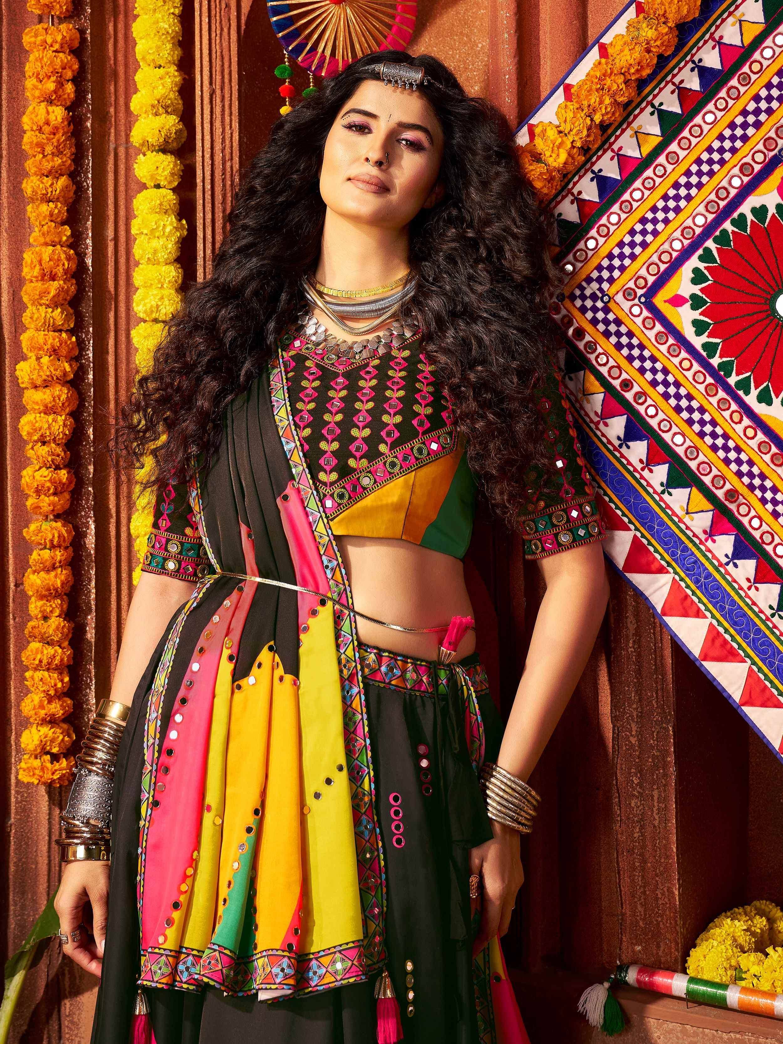Woman in colorful Indian ethnic wear with mirror work, floral garlands, and traditional jewelry