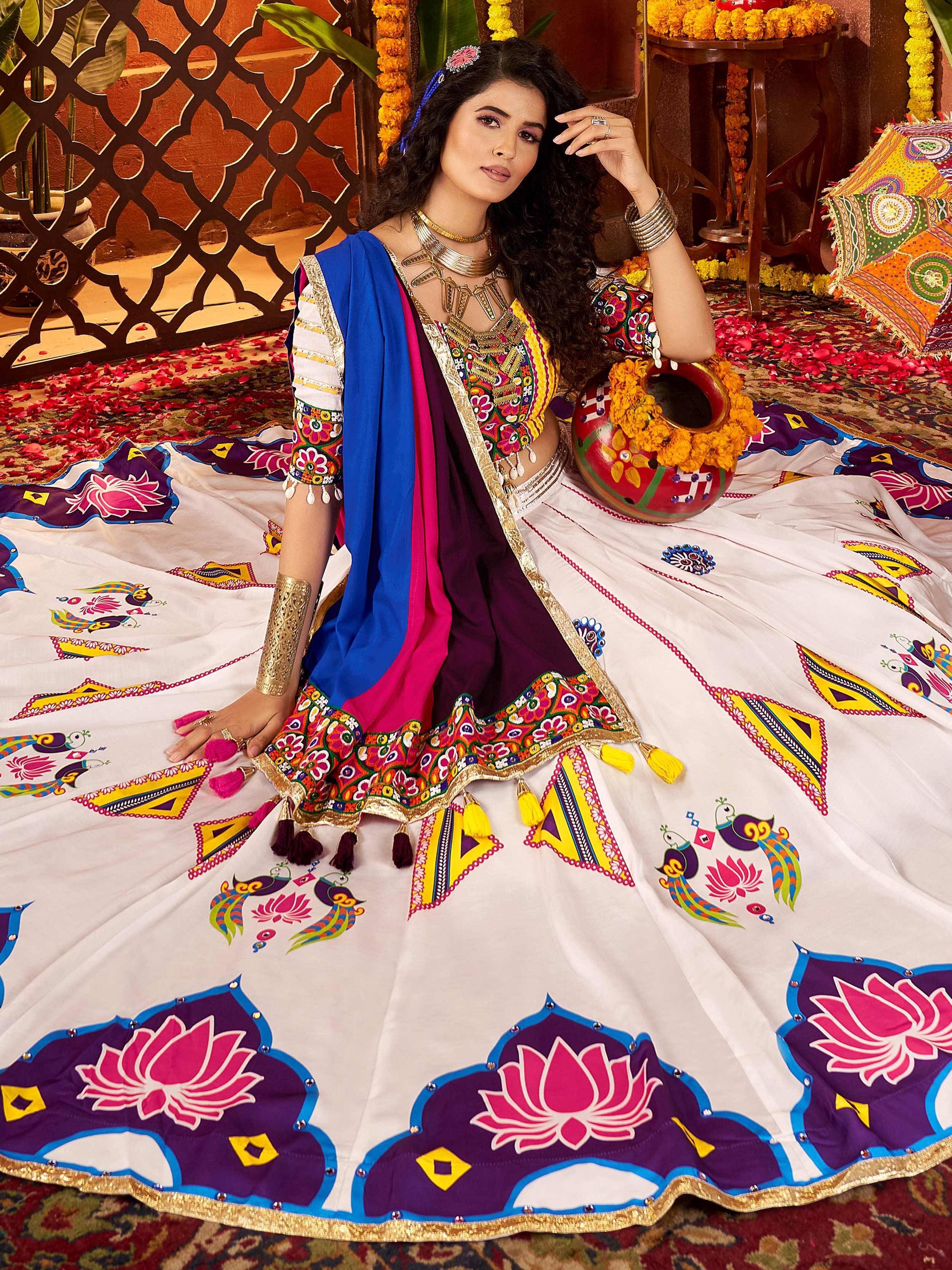 Woman in vibrant Indian ethnic wear with floral and peacock print lehenga choli, perfect for festive occasions.