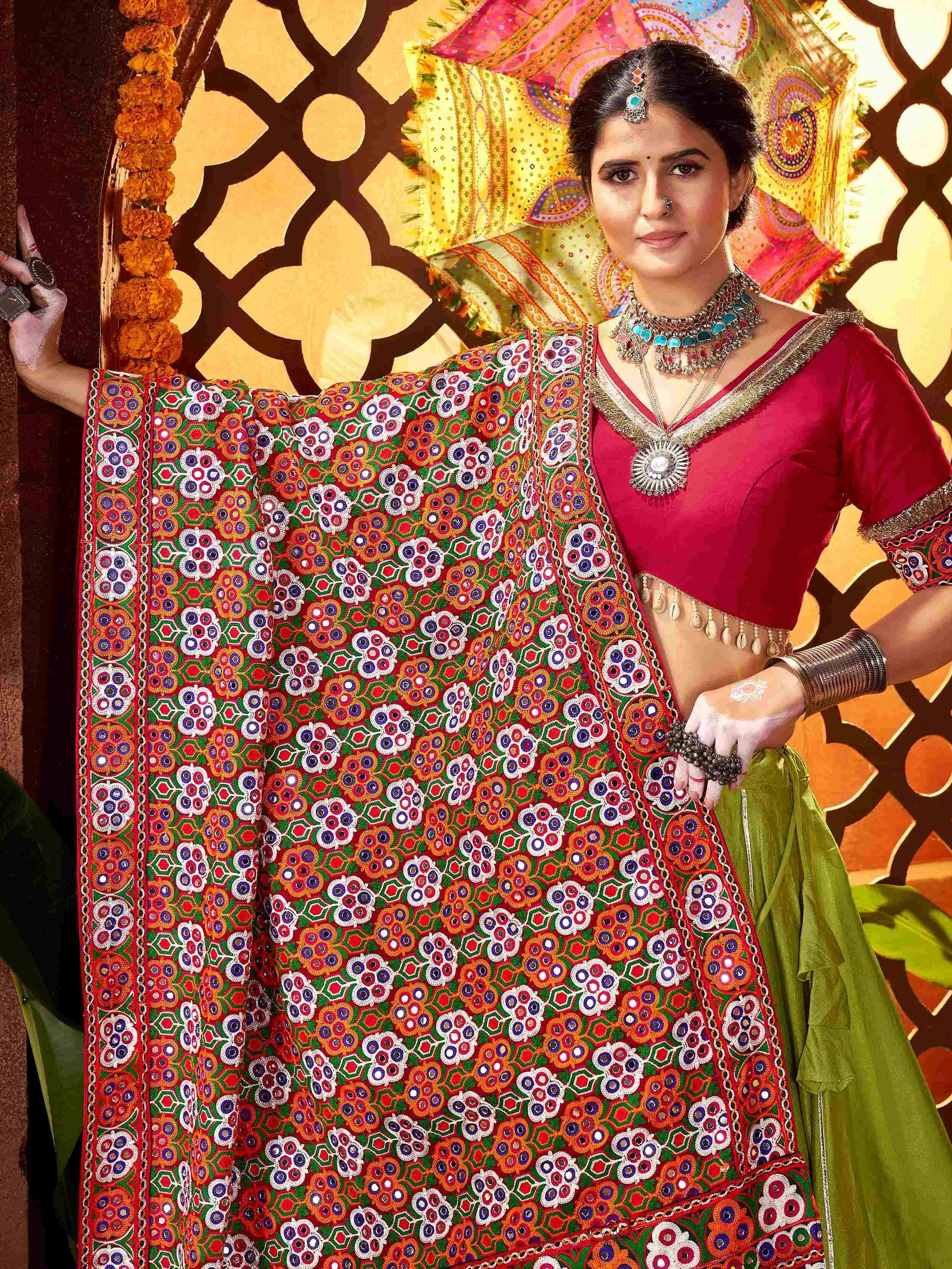 Woman in vibrant mirror-work lehenga choli with ethnic jewelry, traditional Indian attire