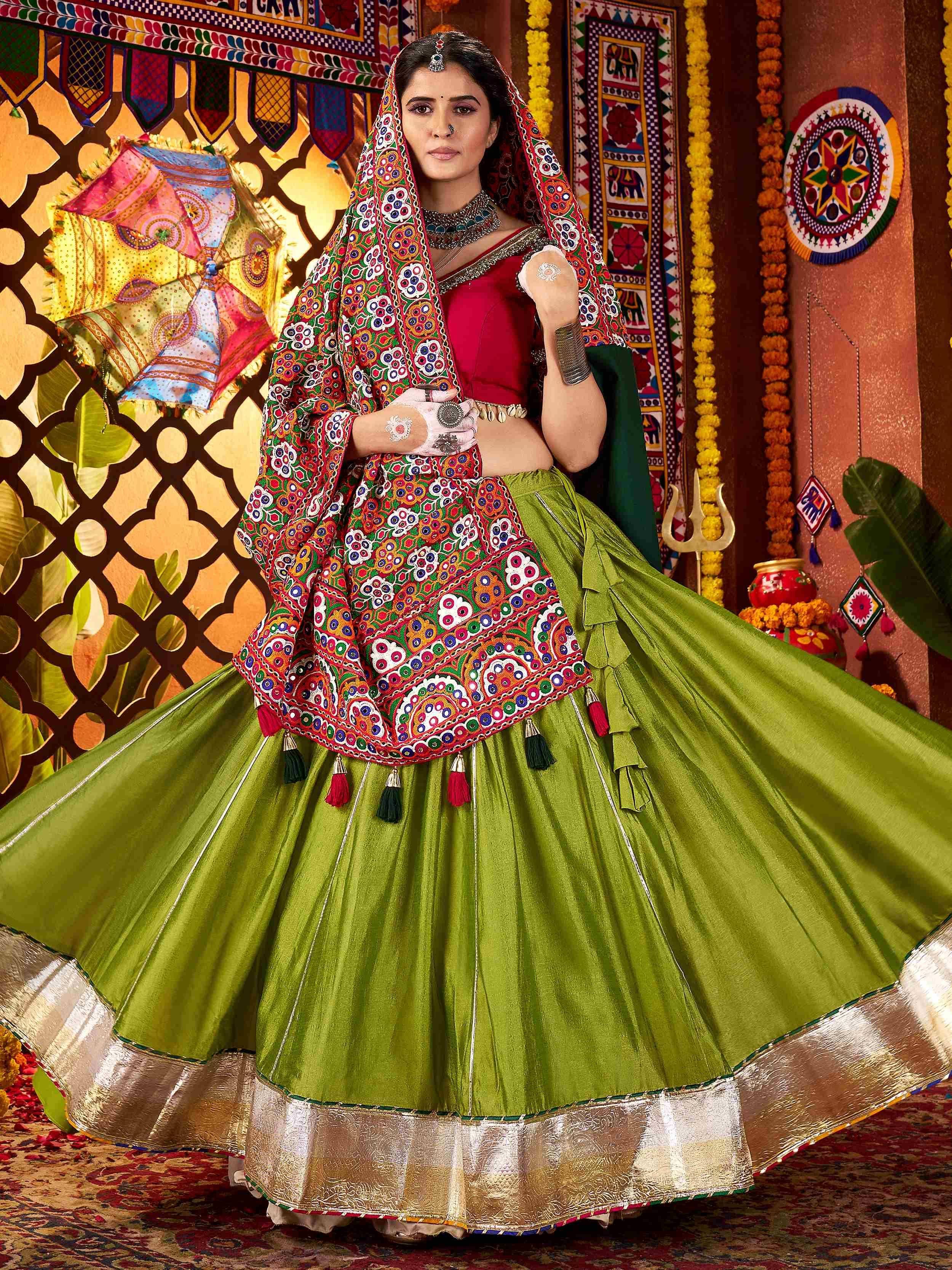Green and red embroidered lehenga choli with mirror work, perfect for Indian ethnic wear and festive occasions.