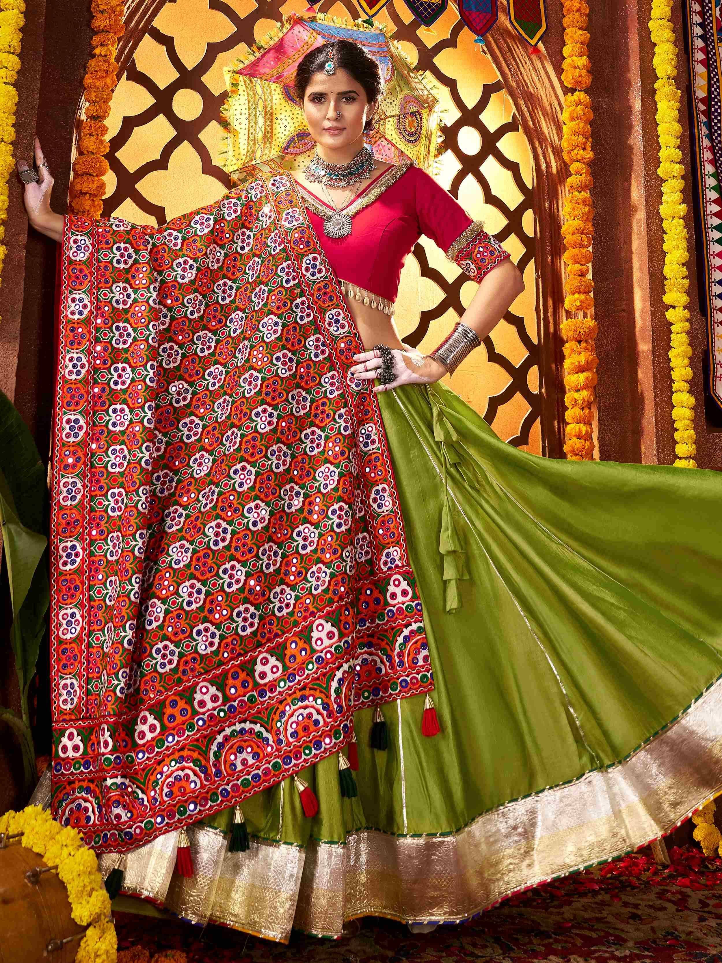 Woman in vibrant green lehenga with mirror work dupatta, traditional Indian ethnic wear