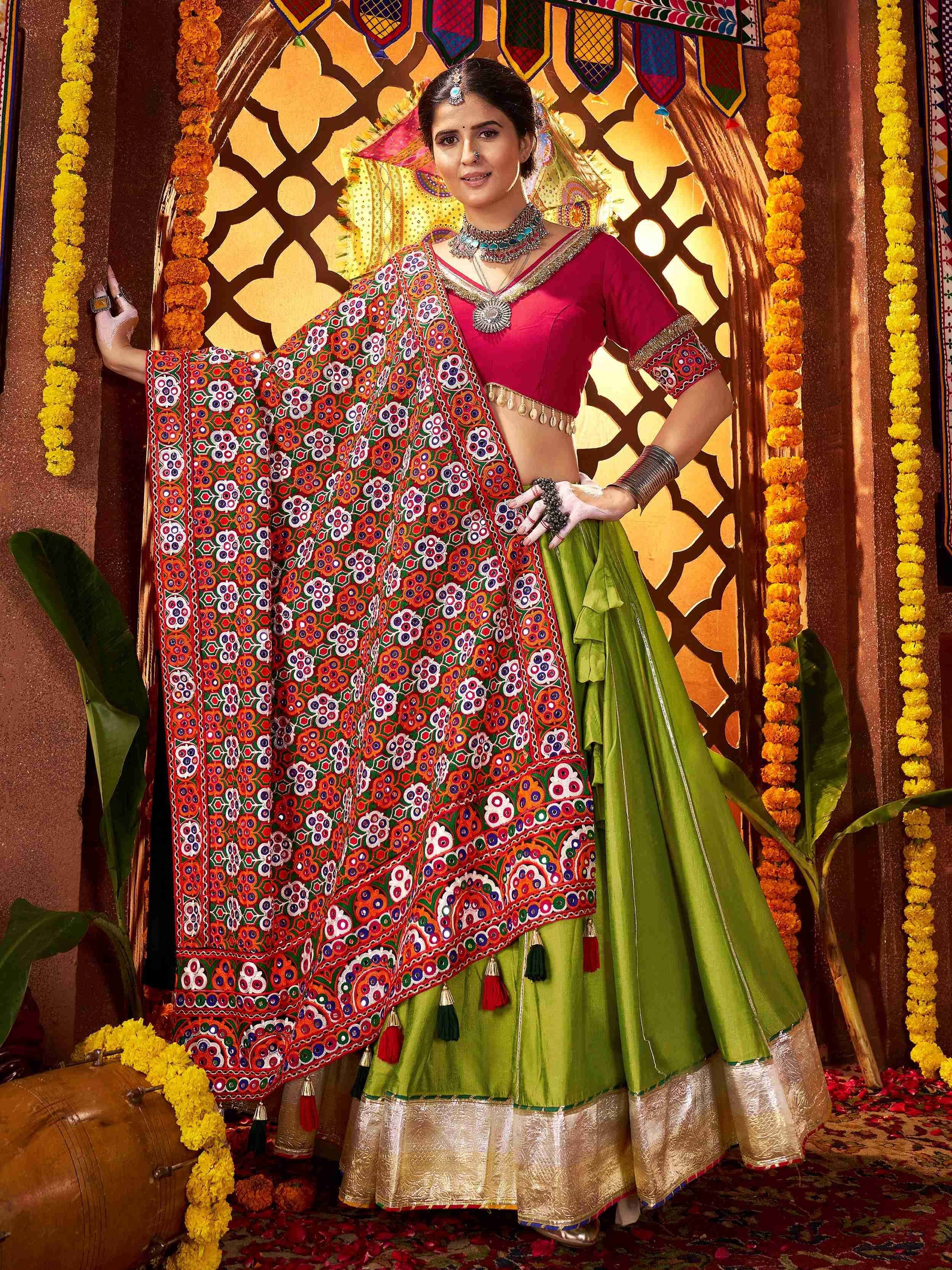 Woman in vibrant green lehenga choli with mirror work dupatta, traditional Indian ethnic wear