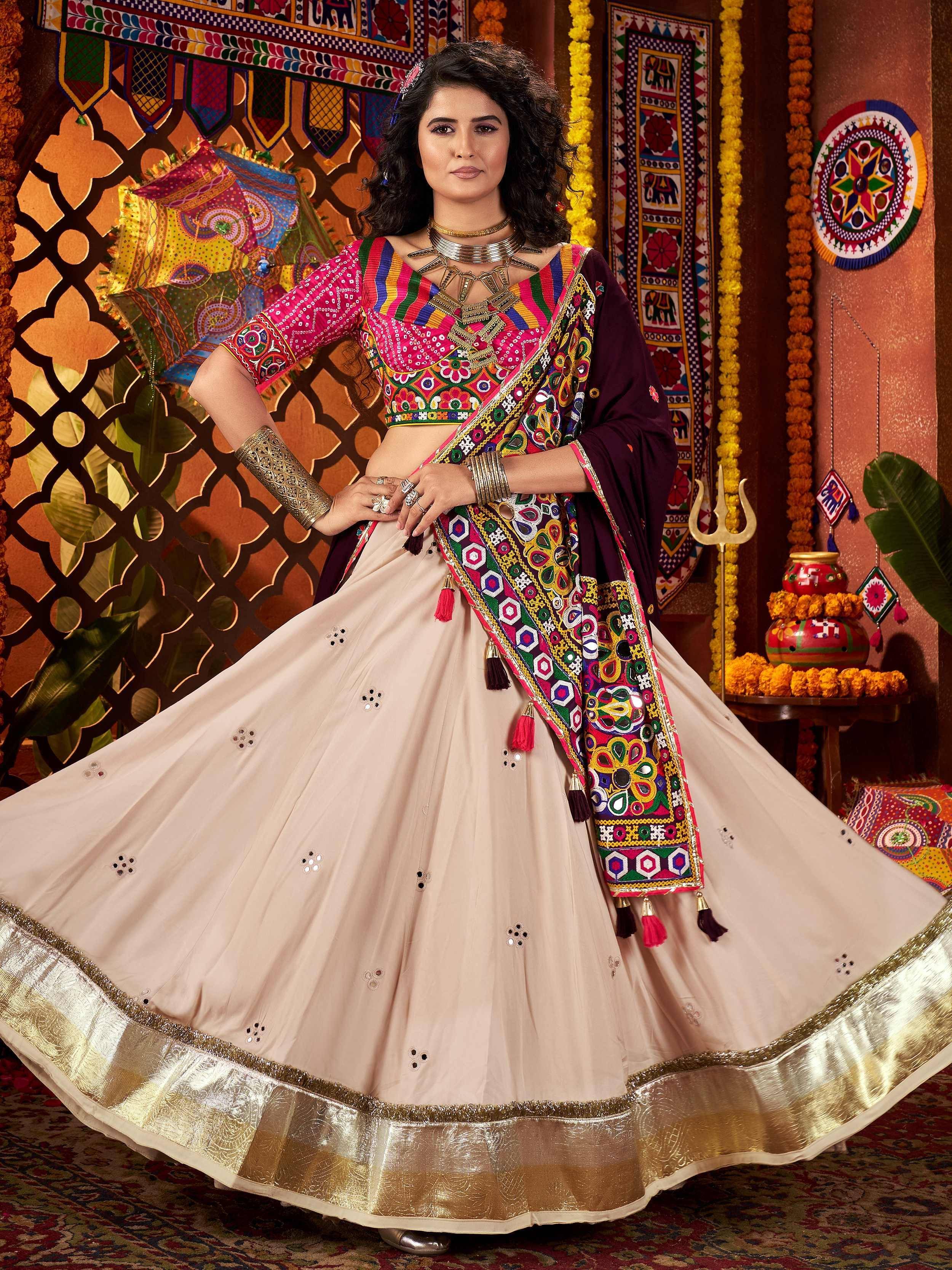 Colorful embroidered lehenga choli with mirror work and gold border, perfect for Indian ethnic wear