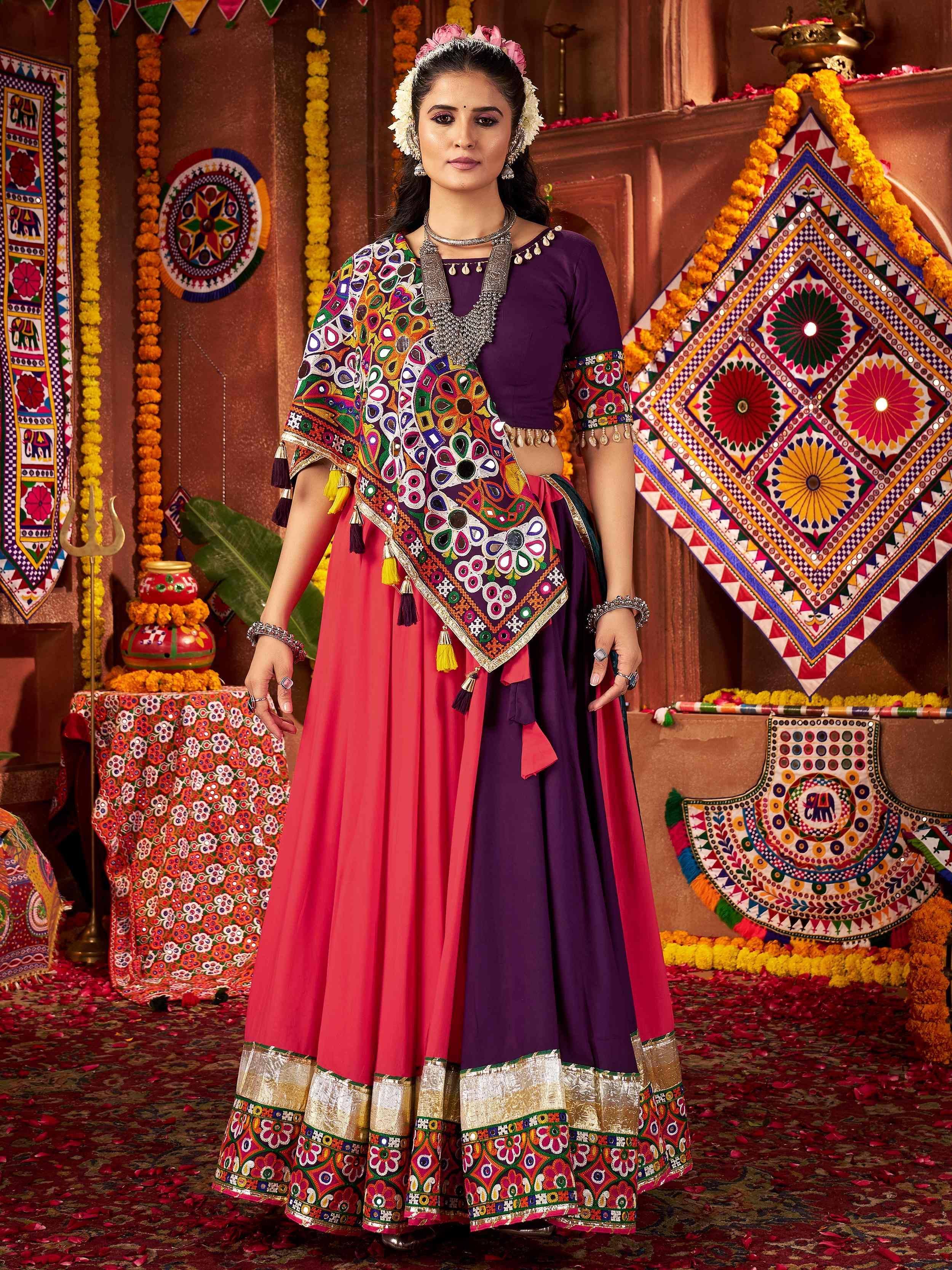 Vibrant purple and pink ethnic lehenga with mirror work and floral embroidery, perfect for festive occasions.
