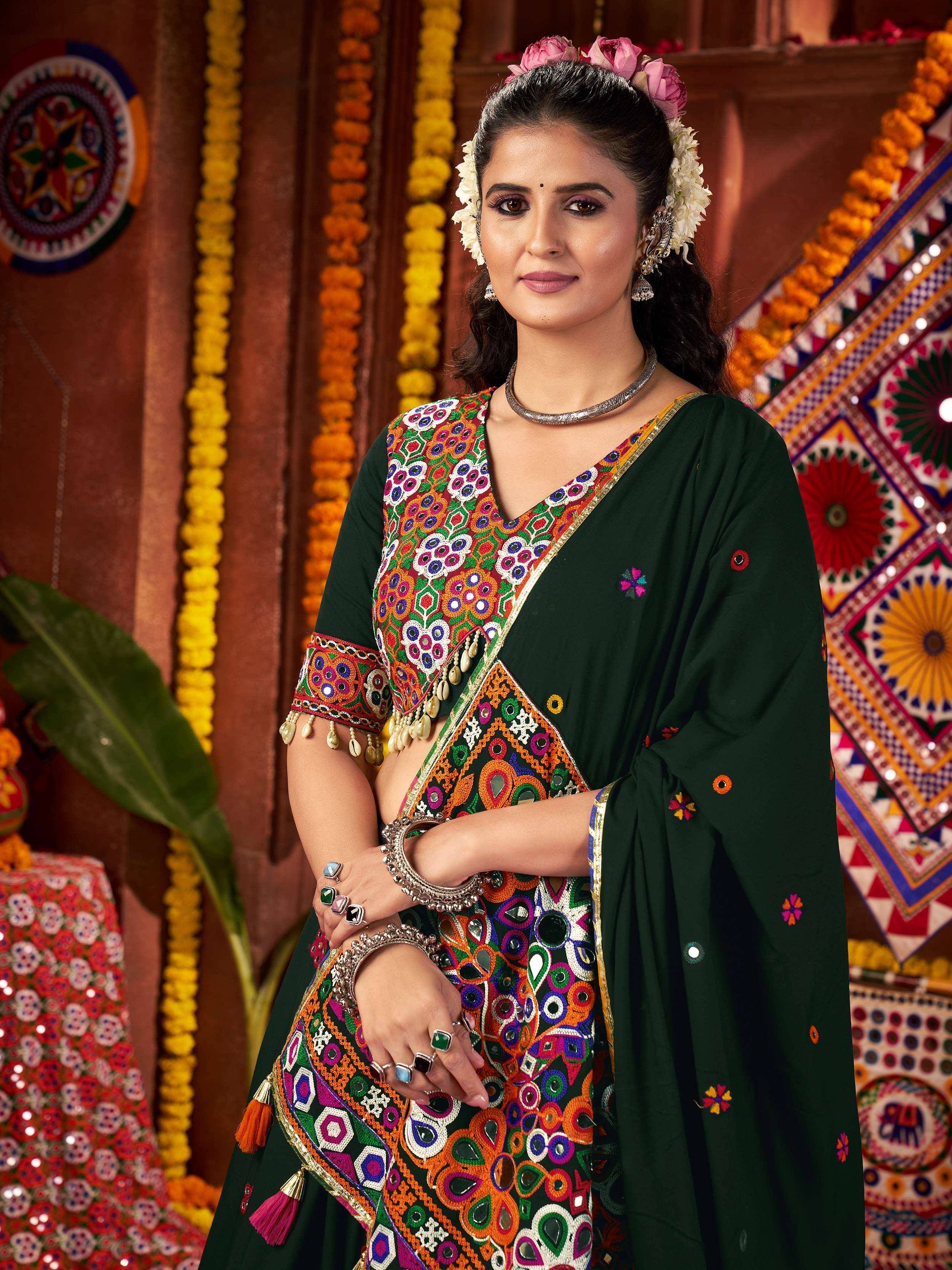 Green embroidered ethnic saree with mirror work and floral accessories