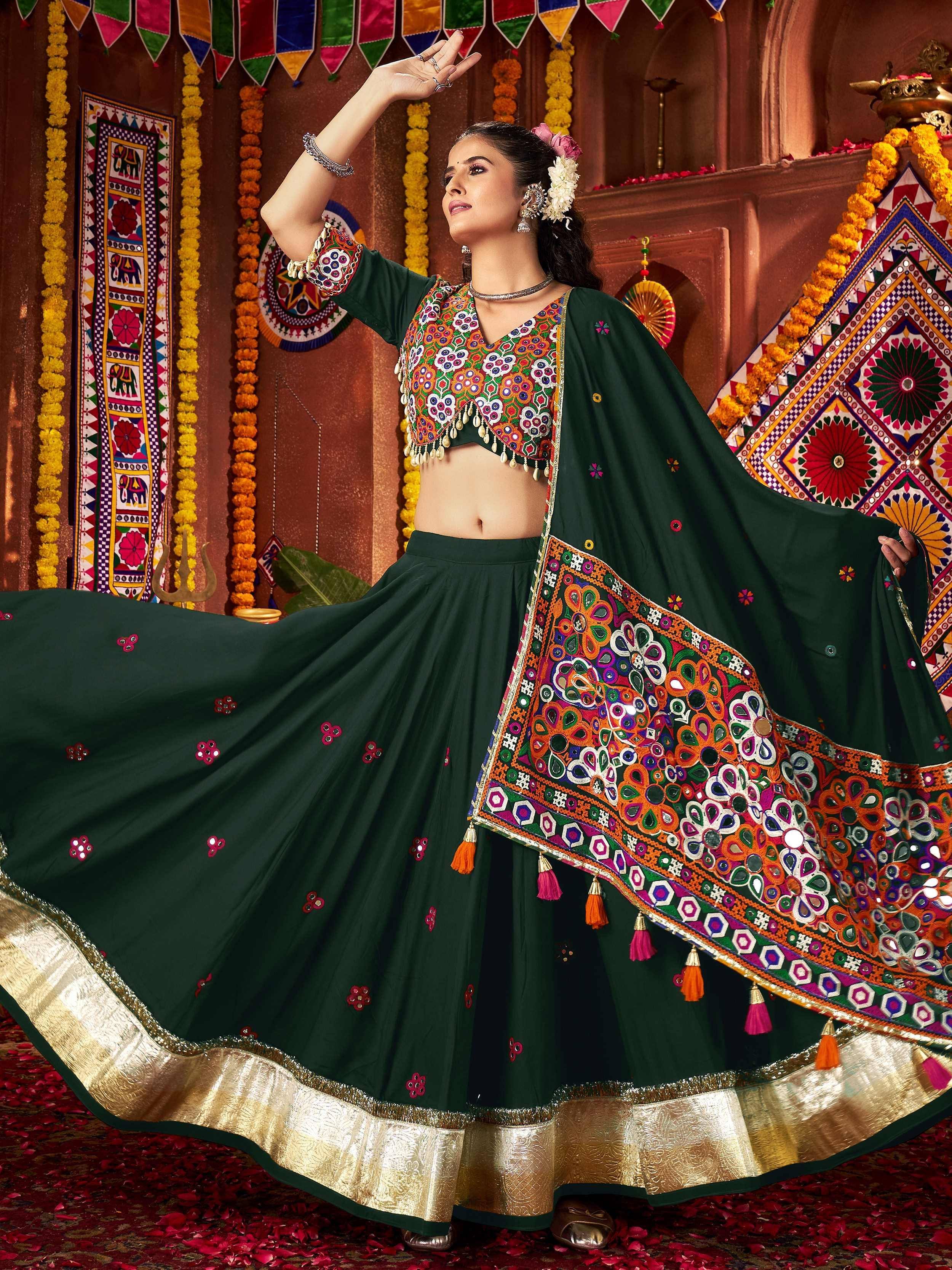 Green embroidered lehenga choli with colorful mirror work and golden border for festive occasions