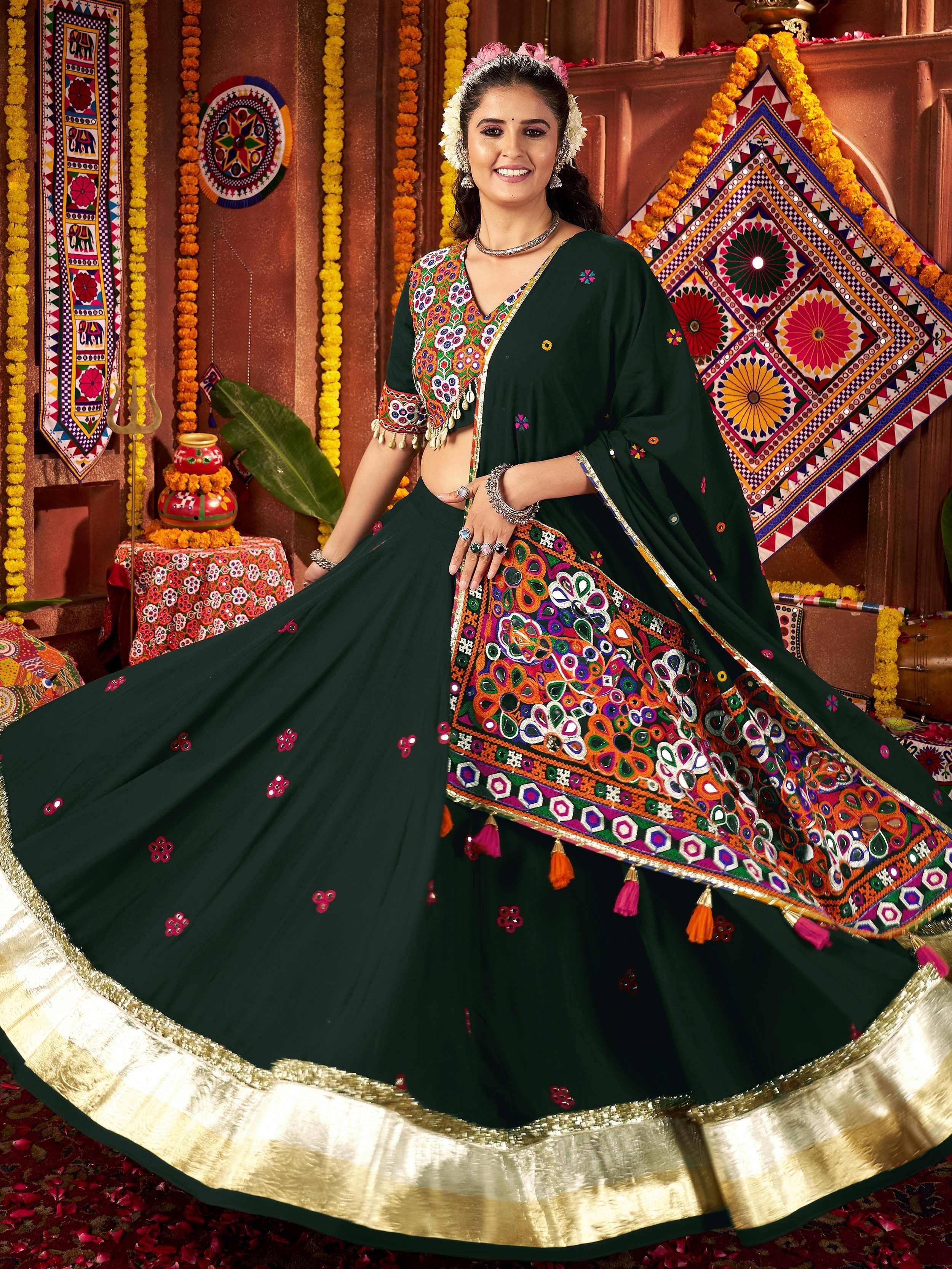 Green embroidered lehenga choli with mirror work and gold border, perfect for Indian ethnic wear