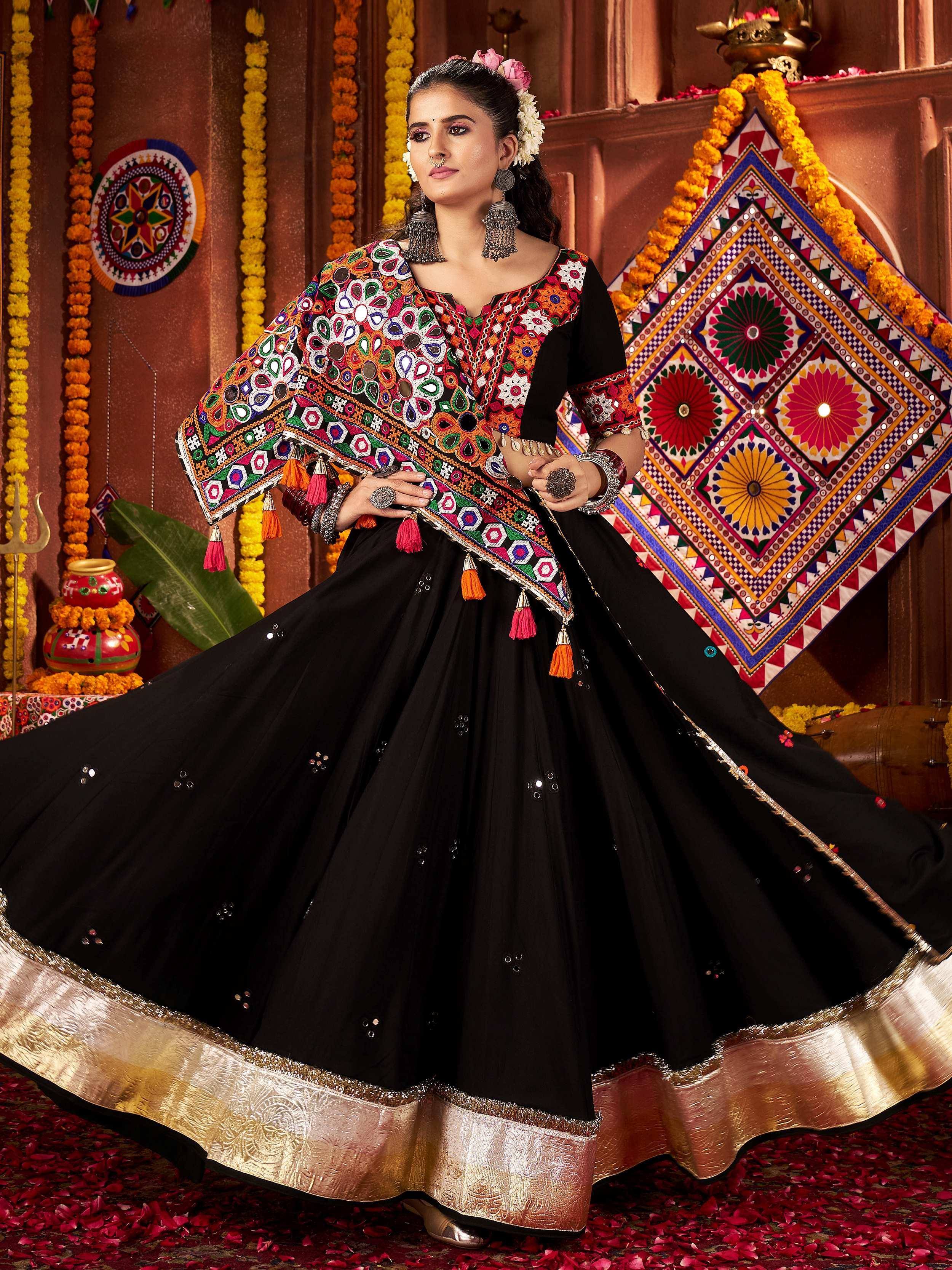 Black embroidered lehenga choli with colorful mirror work and tassels, perfect for Indian ethnic wear
