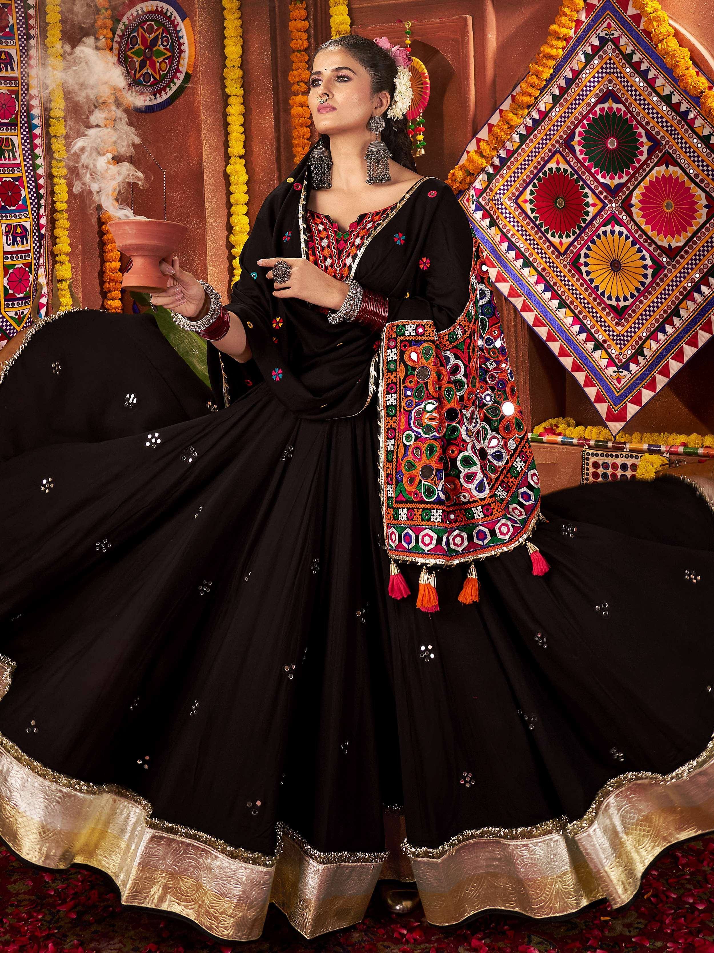 Black embroidered lehenga choli with colorful mirror work and gold border, perfect for Indian ethnic wear.