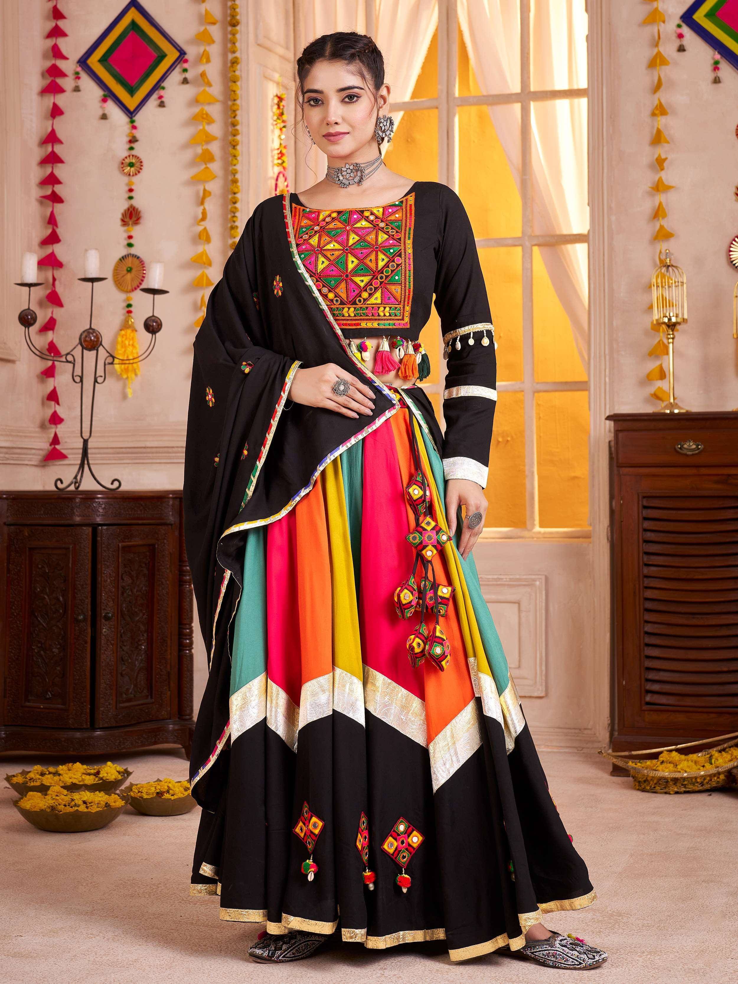 Black embroidered lehenga choli with colorful mirror work and tassels, perfect for Indian ethnic wear