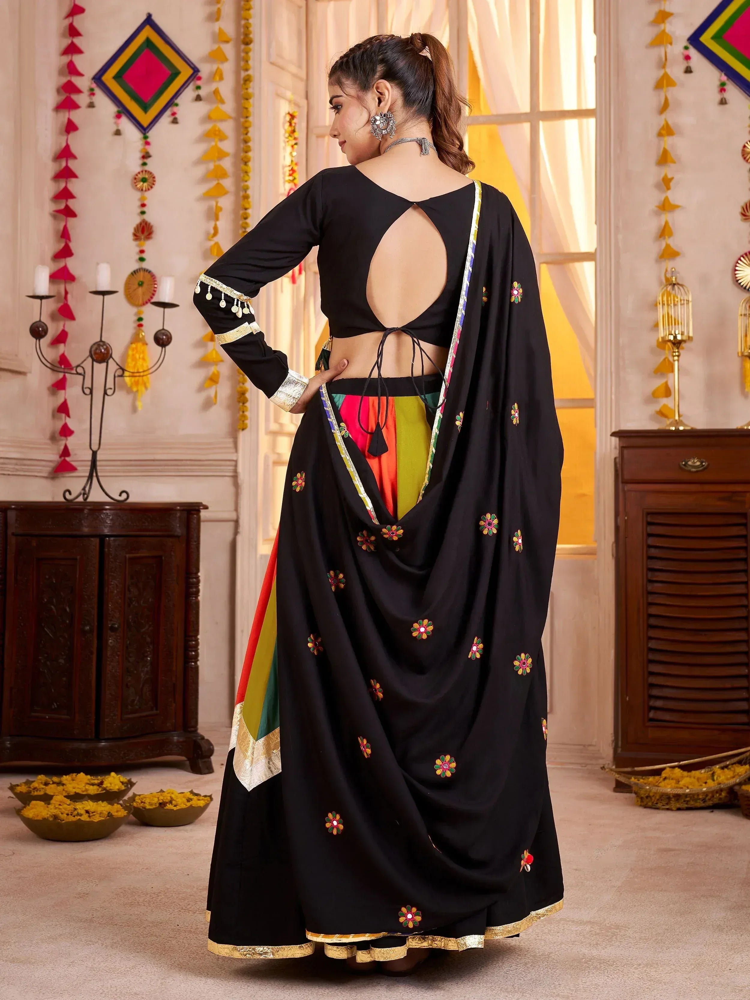Black floral embroidered lehenga choli with colorful panel and back cutout, ethnic Indian wear