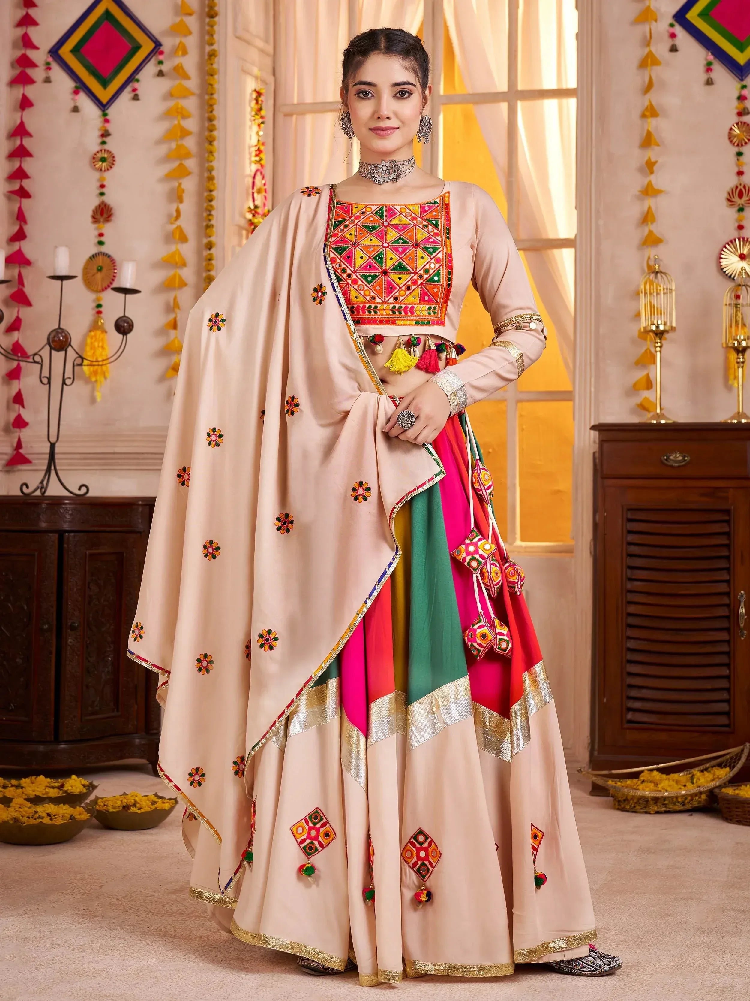 Woman in colorful embroidered Indian ethnic wear with mirror work and tassels, perfect for festive occasions