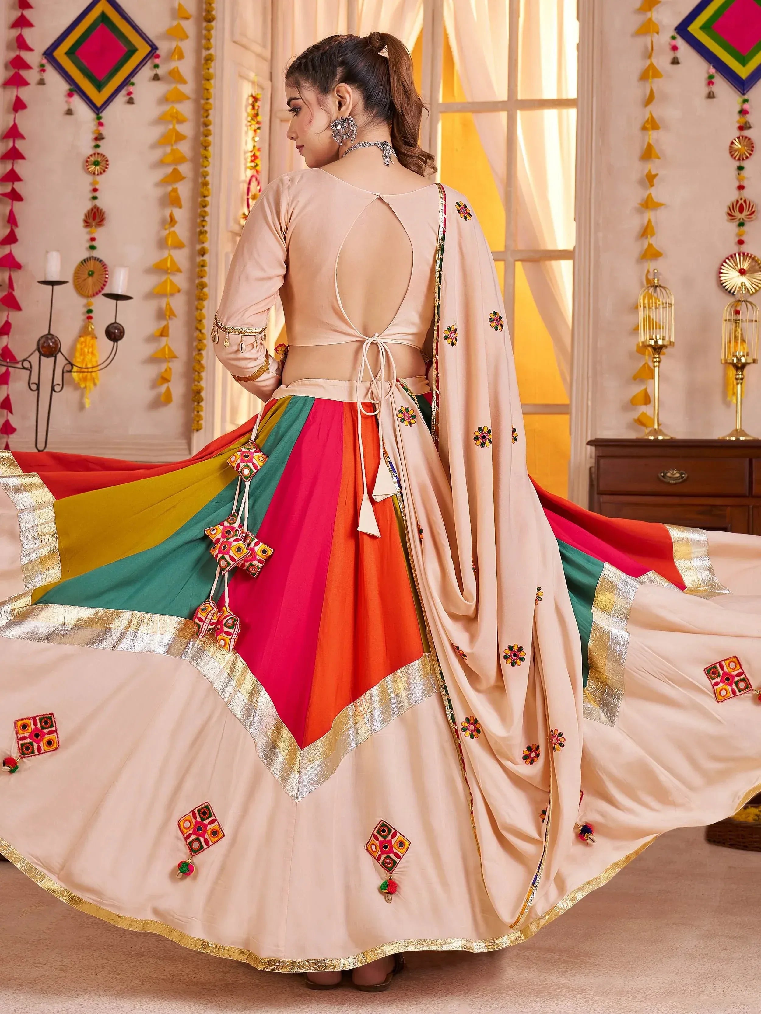 Woman in colorful Indian ethnic lehenga choli with floral embroidery, back view, festive decor
