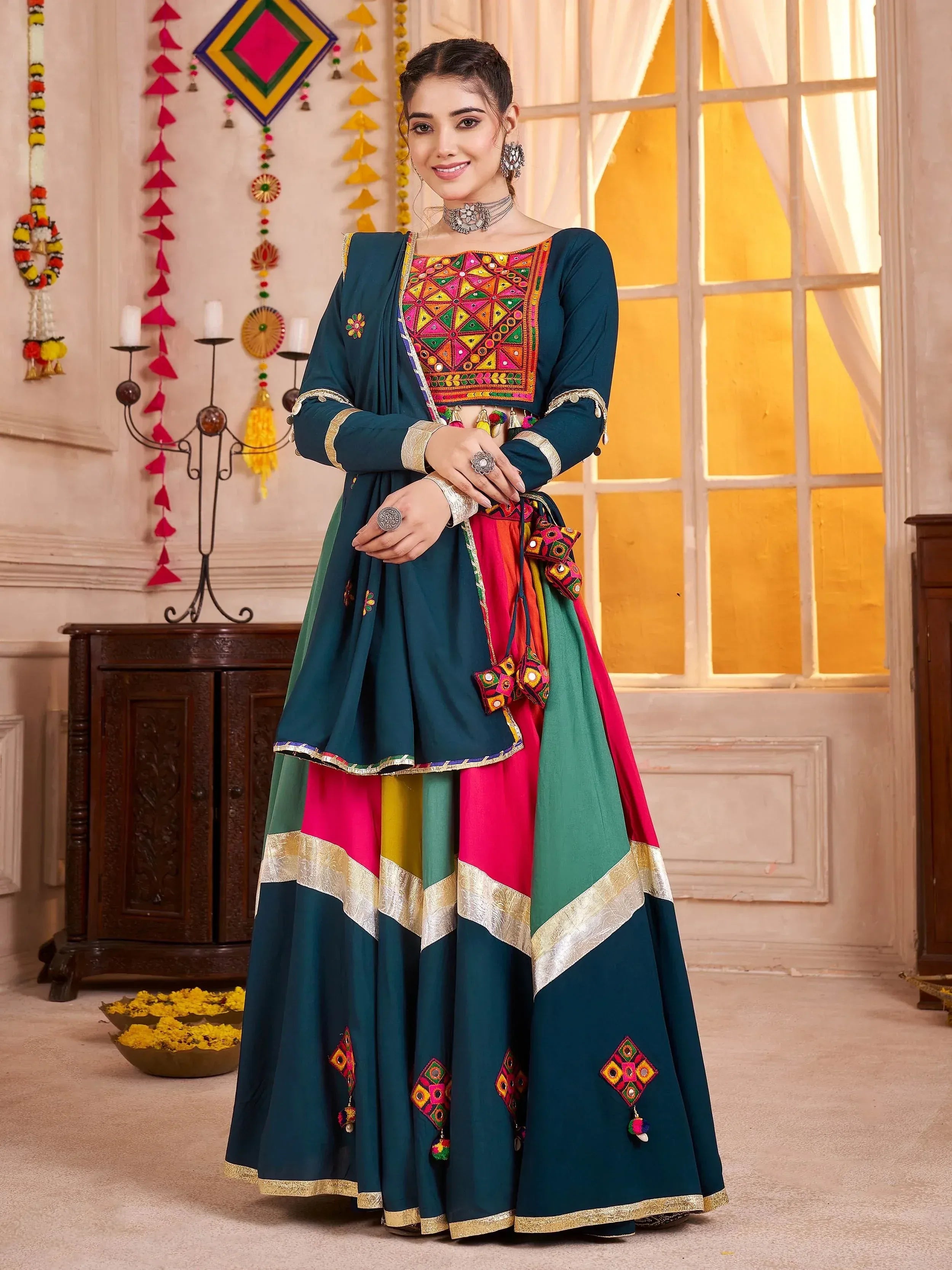 Woman in vibrant Indian ethnic wear with mirror work, colorful lehenga choli, and traditional jewelry