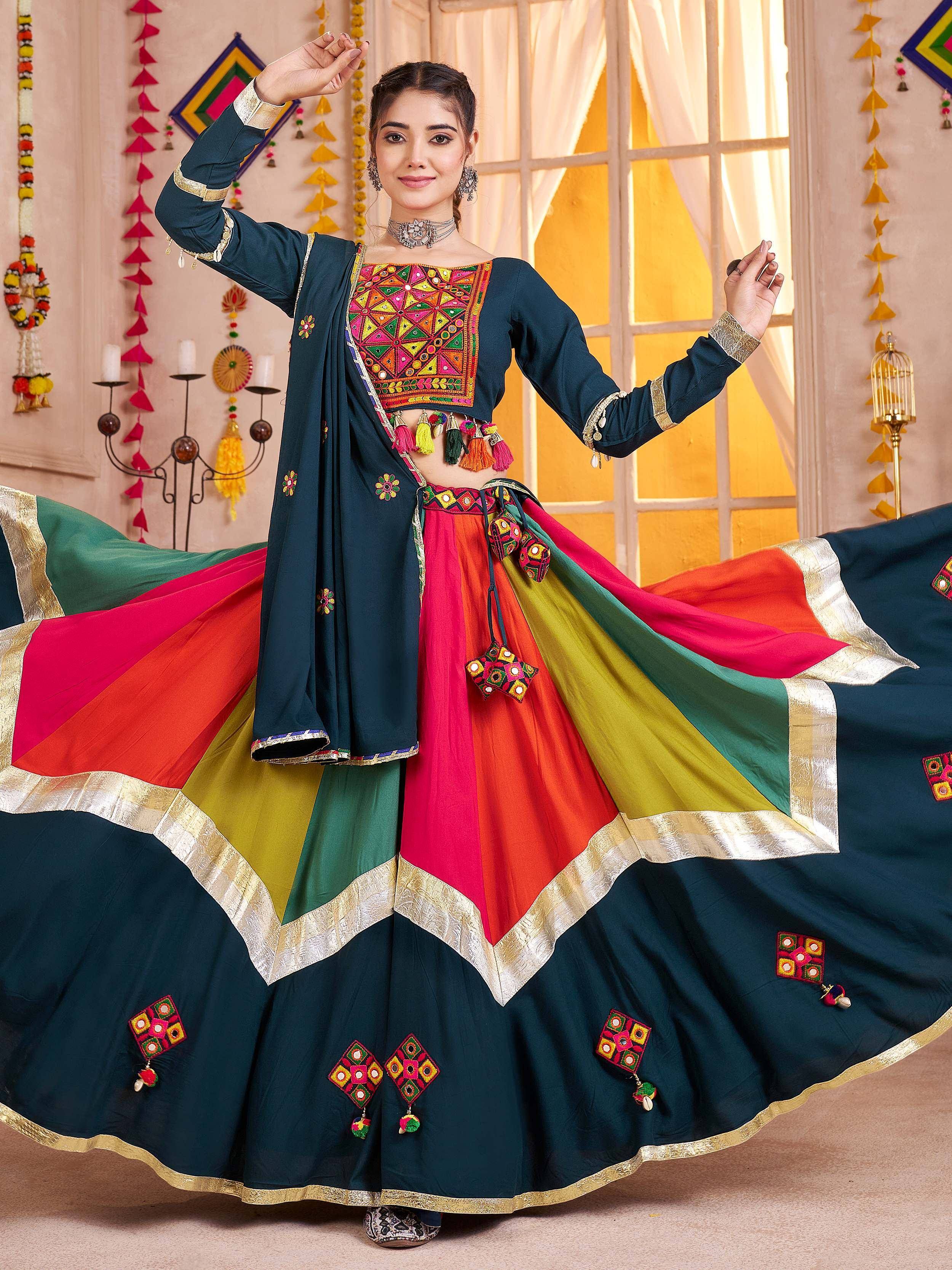 Woman in vibrant Indian ethnic wear with mirror work, colorful lehenga, and dupatta for festive occasions