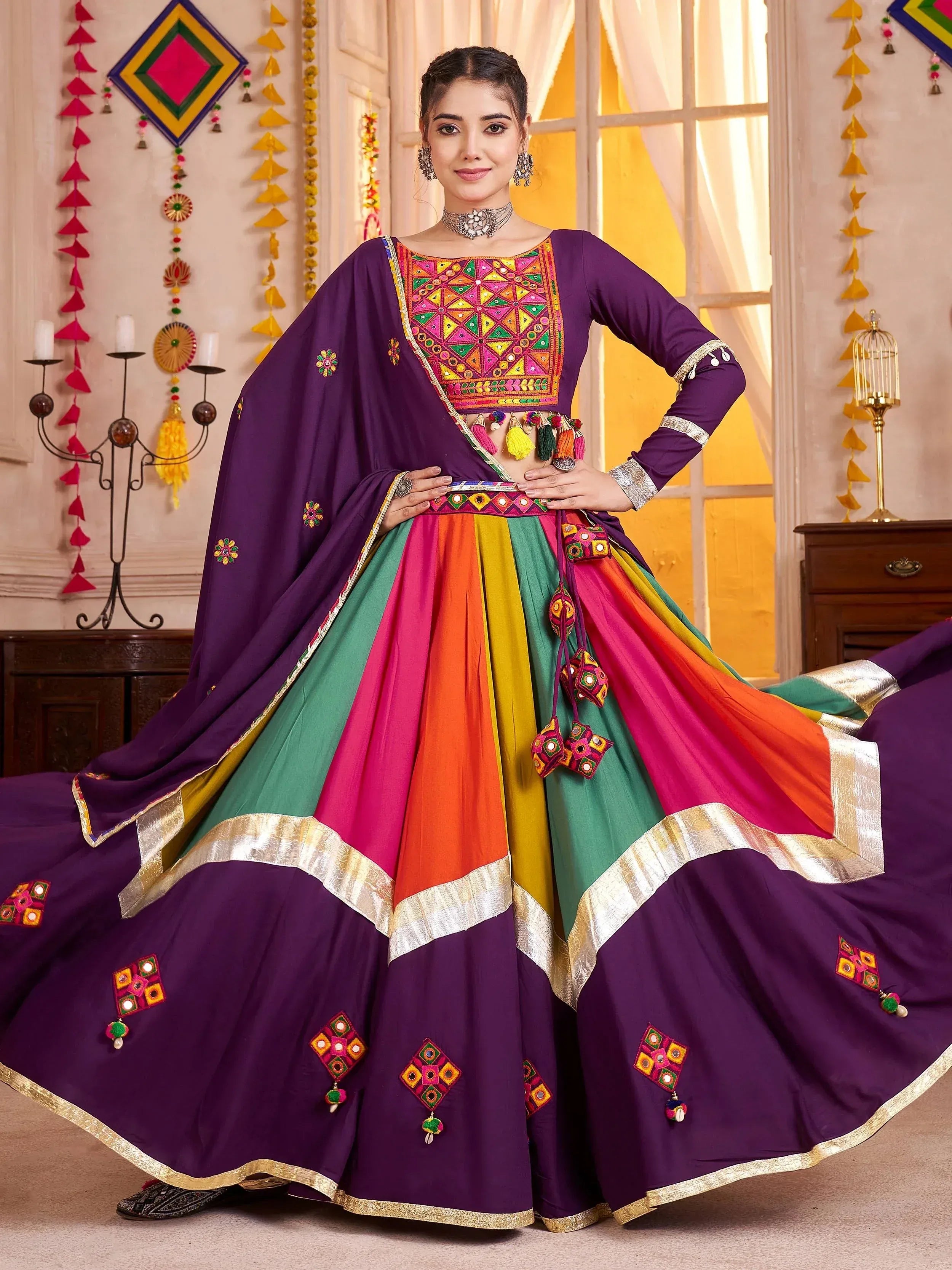 Vibrant purple and multicolor Indian lehenga choli with mirror work and tassels, perfect for festive occasions.