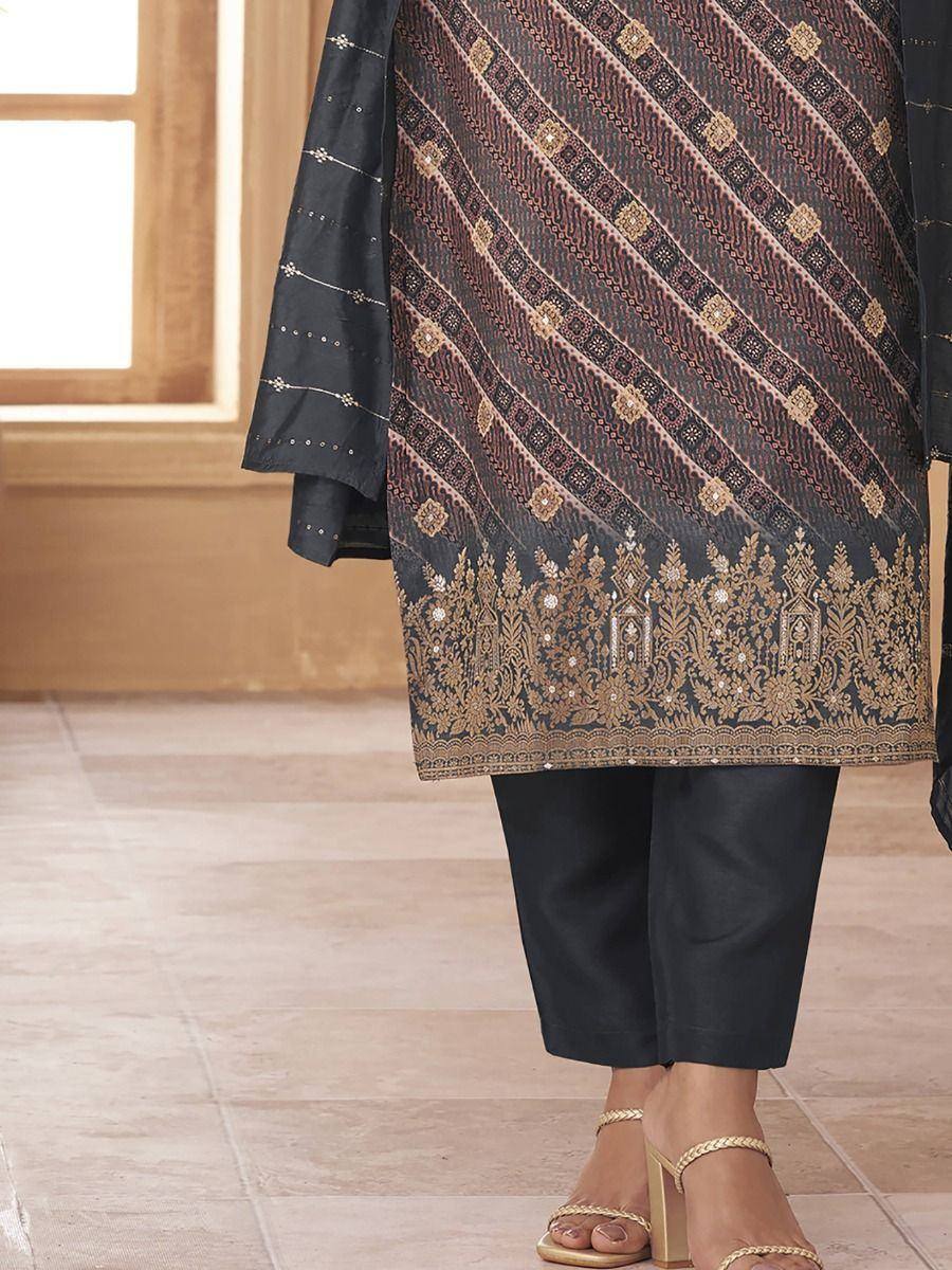Black embroidered salwar kameez with gold detailing, paired with matching pants and heels