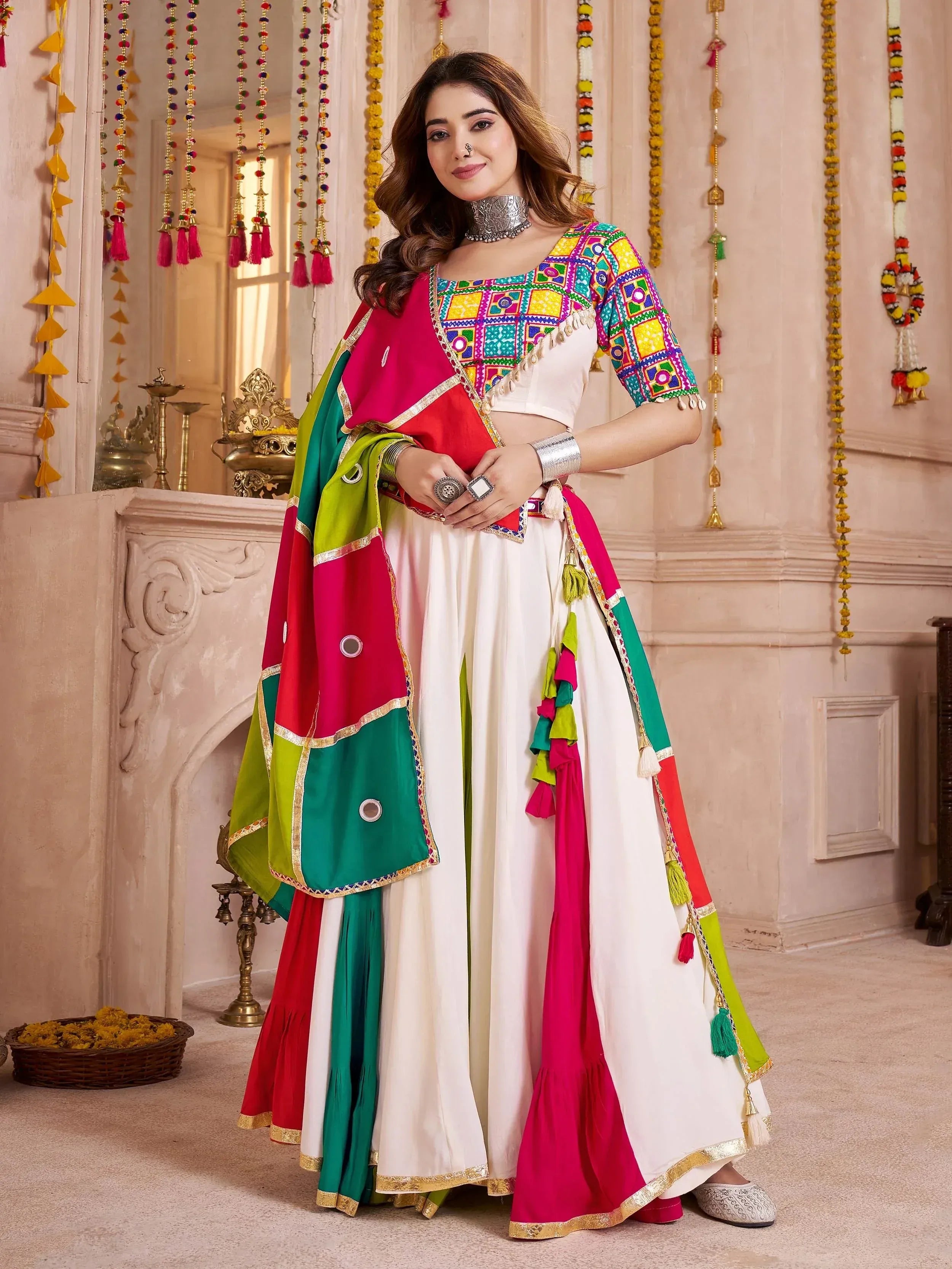 Colorful Indian ethnic wear with mirror work blouse, white lehenga, and vibrant dupatta for festive occasions
