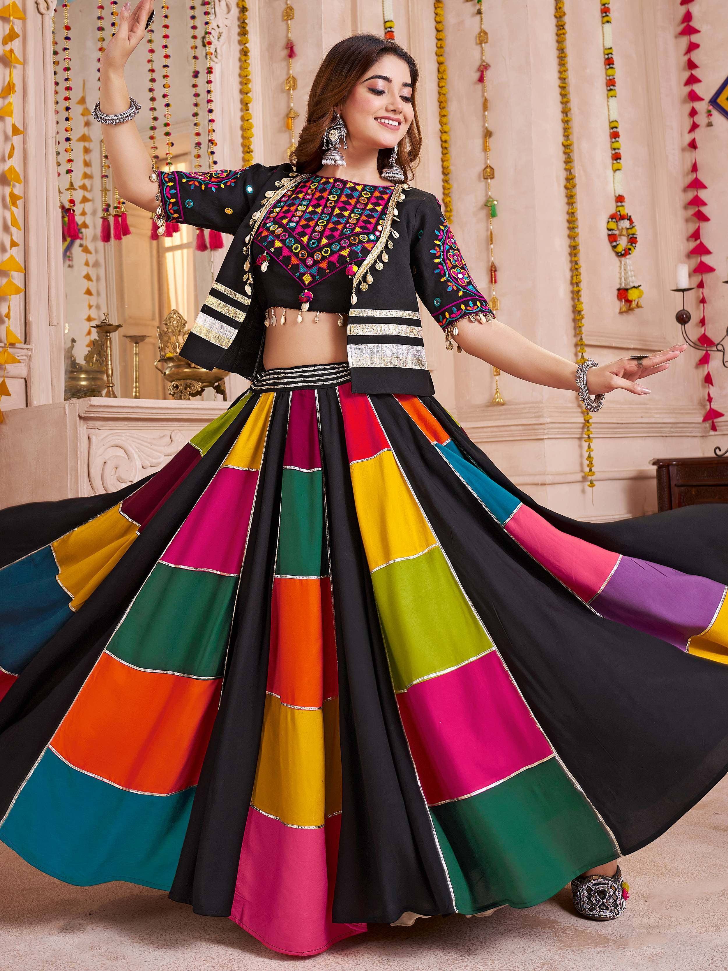 Woman in vibrant multicolor ethnic lehenga choli with mirror work, perfect for festive occasions.