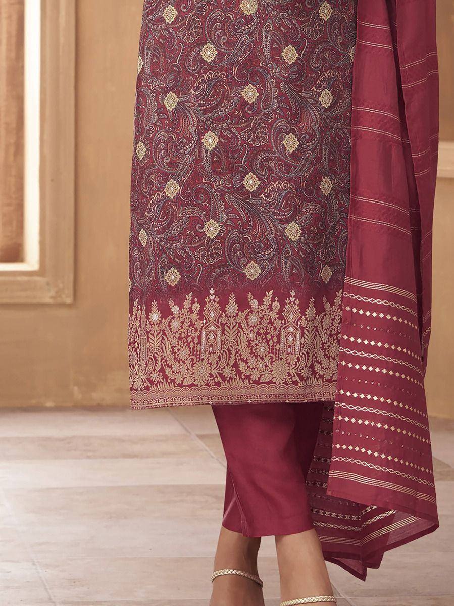 Maroon ethnic salwar kameez with gold paisley print and embroidered hem, paired with matching dupatta